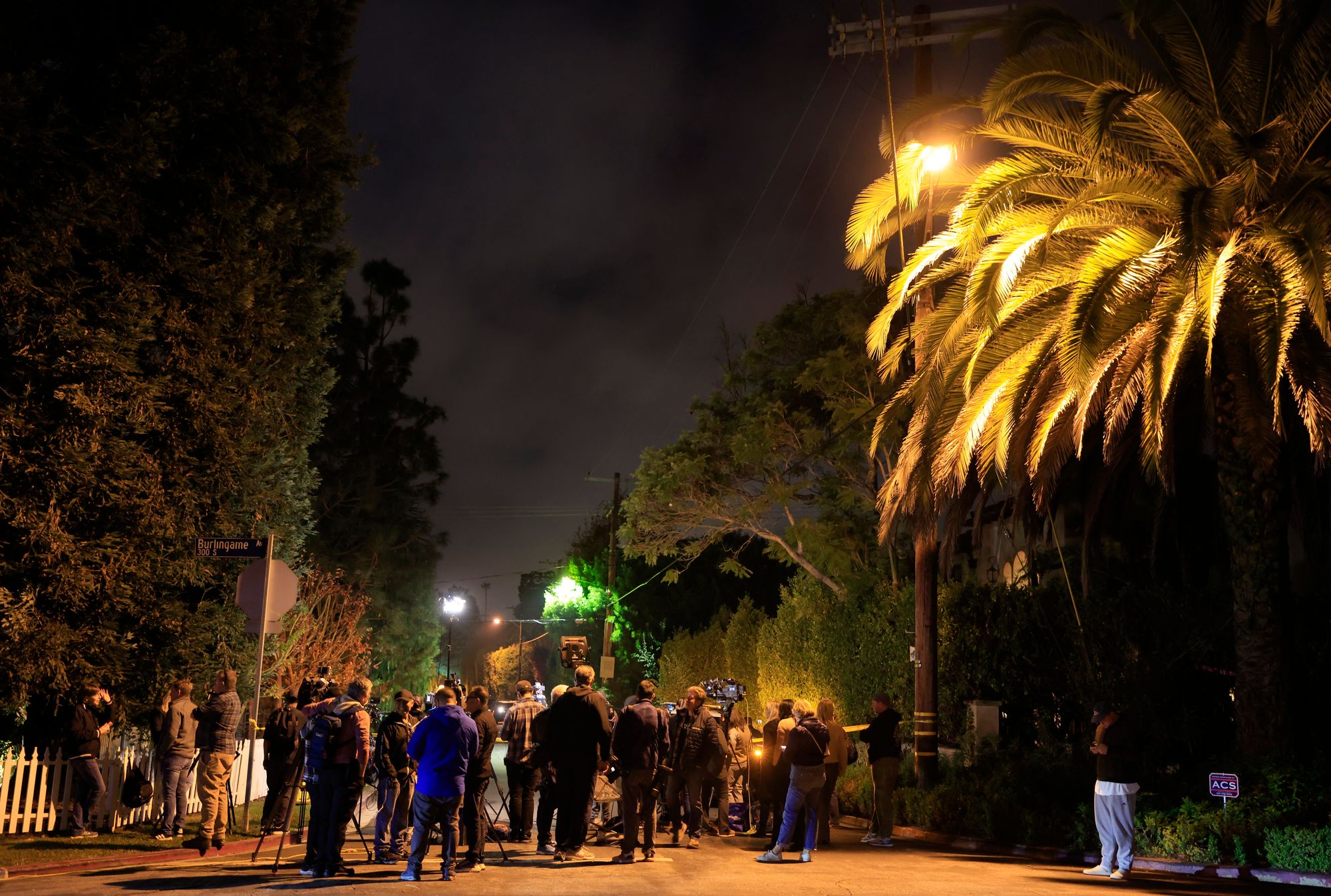 Police, media and neighbors outside the Reiners’ home in Brentwood on Sunday evening. A neighbor said Larry David and Billy Crystal visited the scene separately