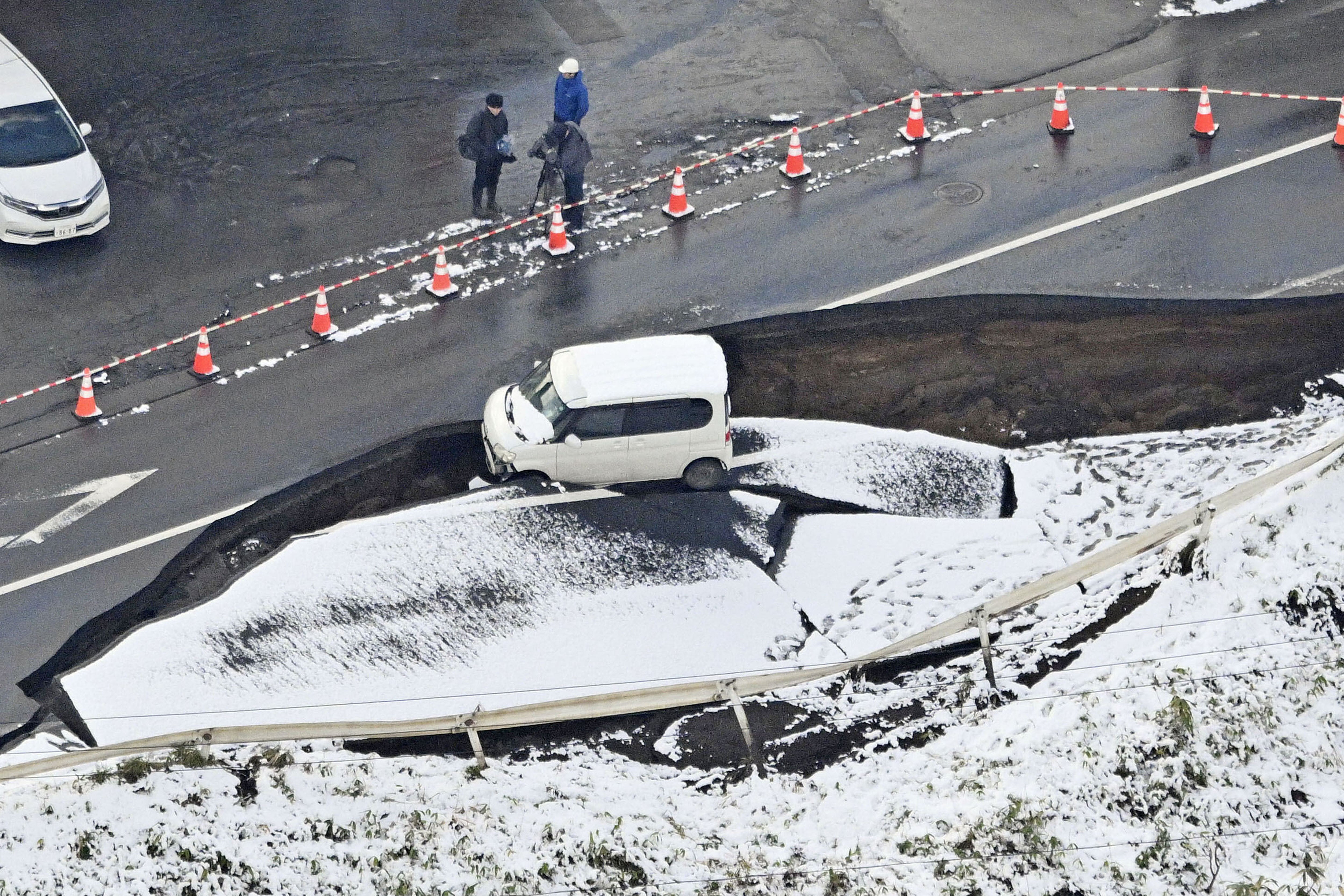 <p>This aerial photo shows a vehicle sitting on a damaged road in Tohoku town, Aomori prefecture, northern Japan Tuesday, 9 December 2025, following a powerful earthquake on late Monday</p>