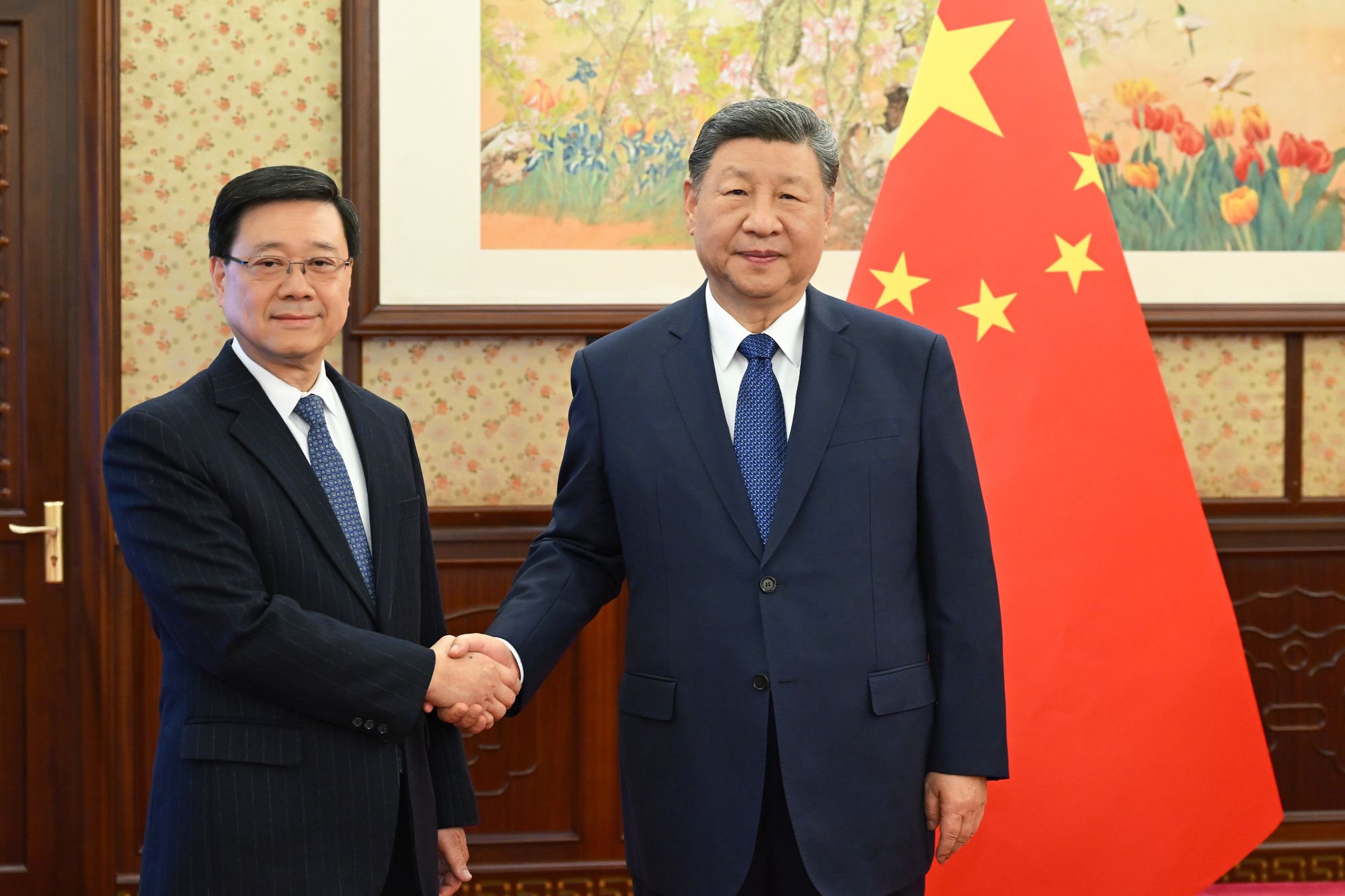<p>Hong Kong chief executive John Lee, left, shakes hands with Chinese president Xi Jinping </p>