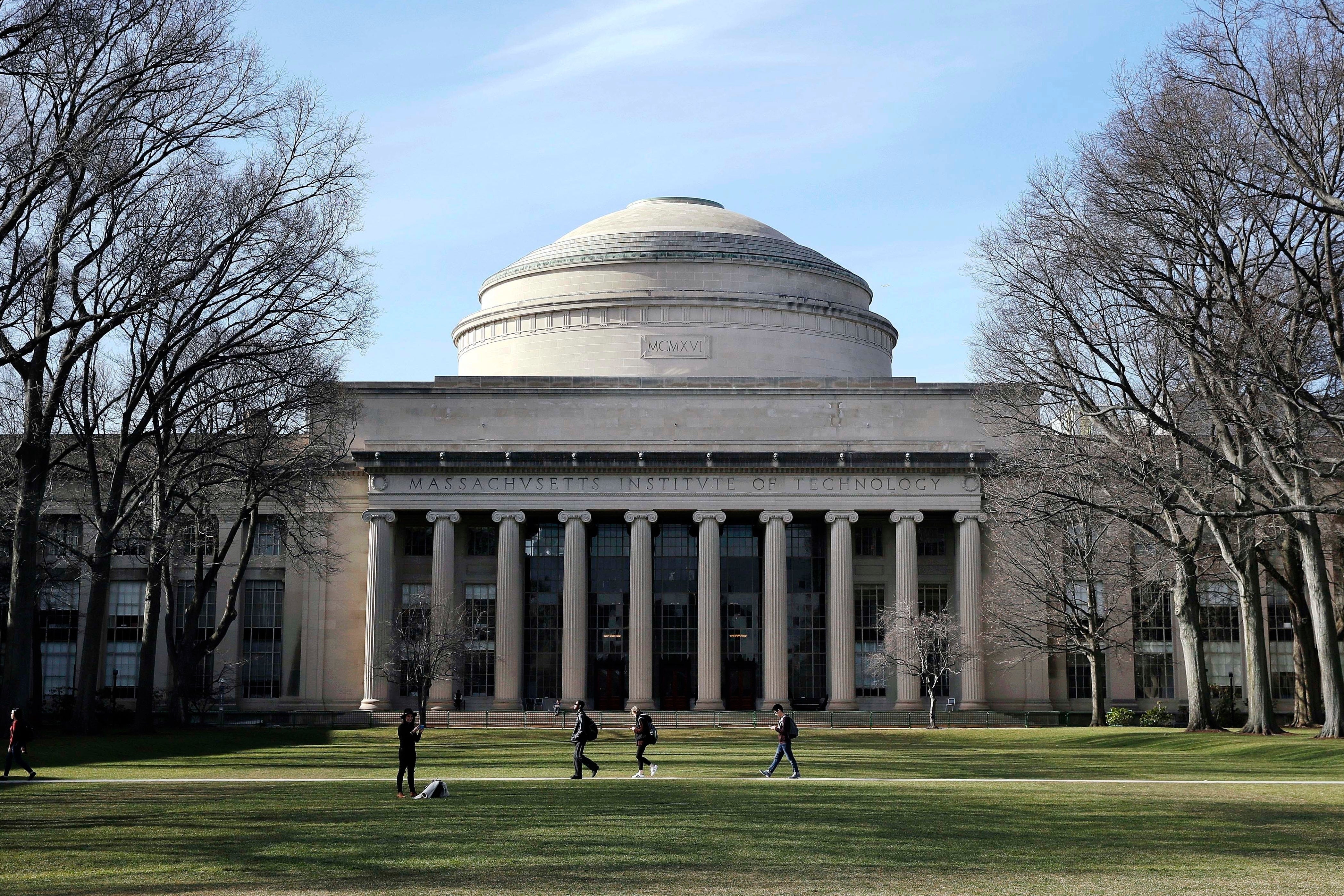 Students walk past the ’Great Dome‘ atop Building 10 on the Massachusetts Institute of Technology campus in Cambridge, Mass.