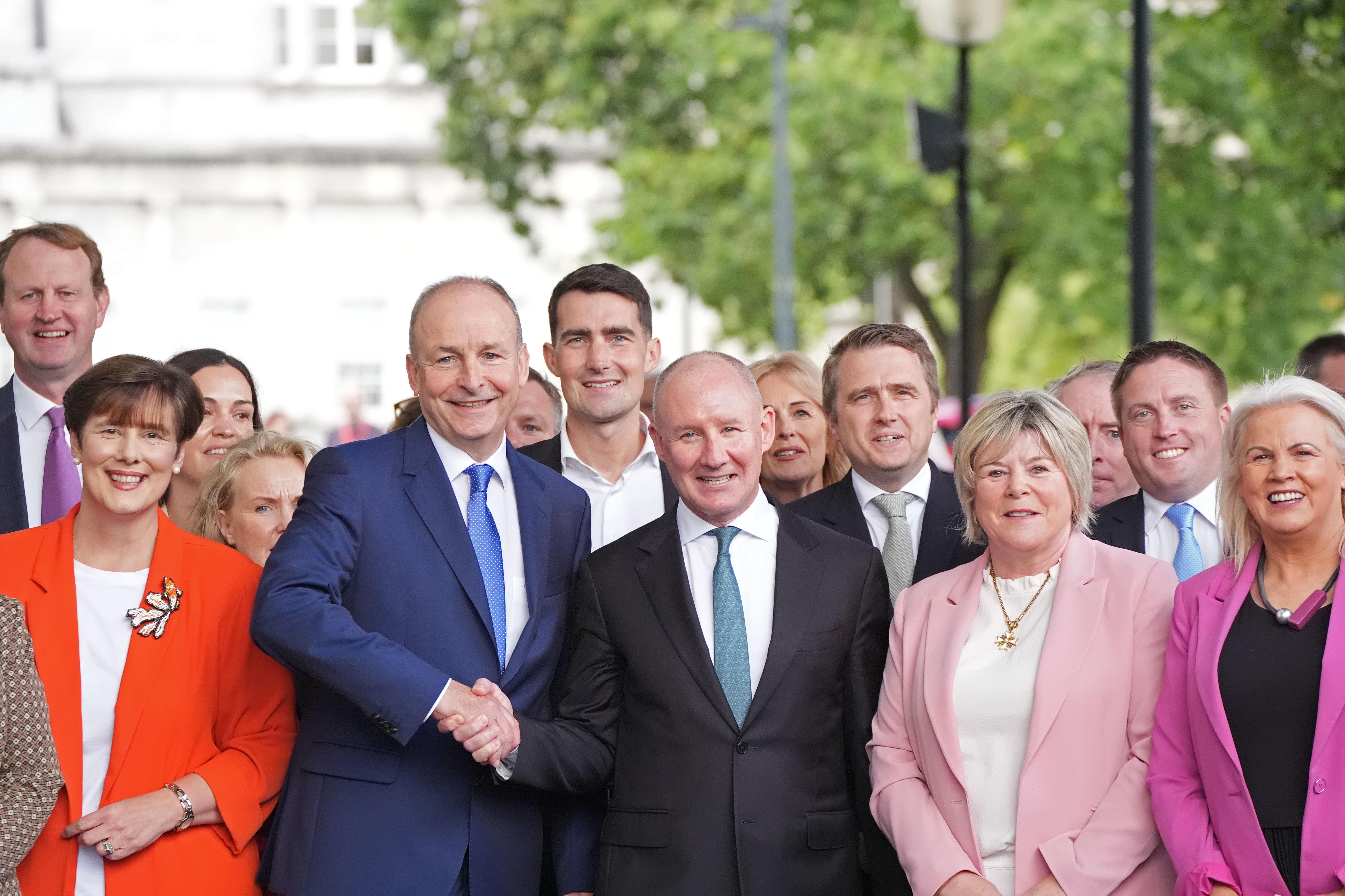 Taoiseach Micheal Martin (centre left) with former Dublin Gaelic football manager Jim Gavin and supporters (PA)