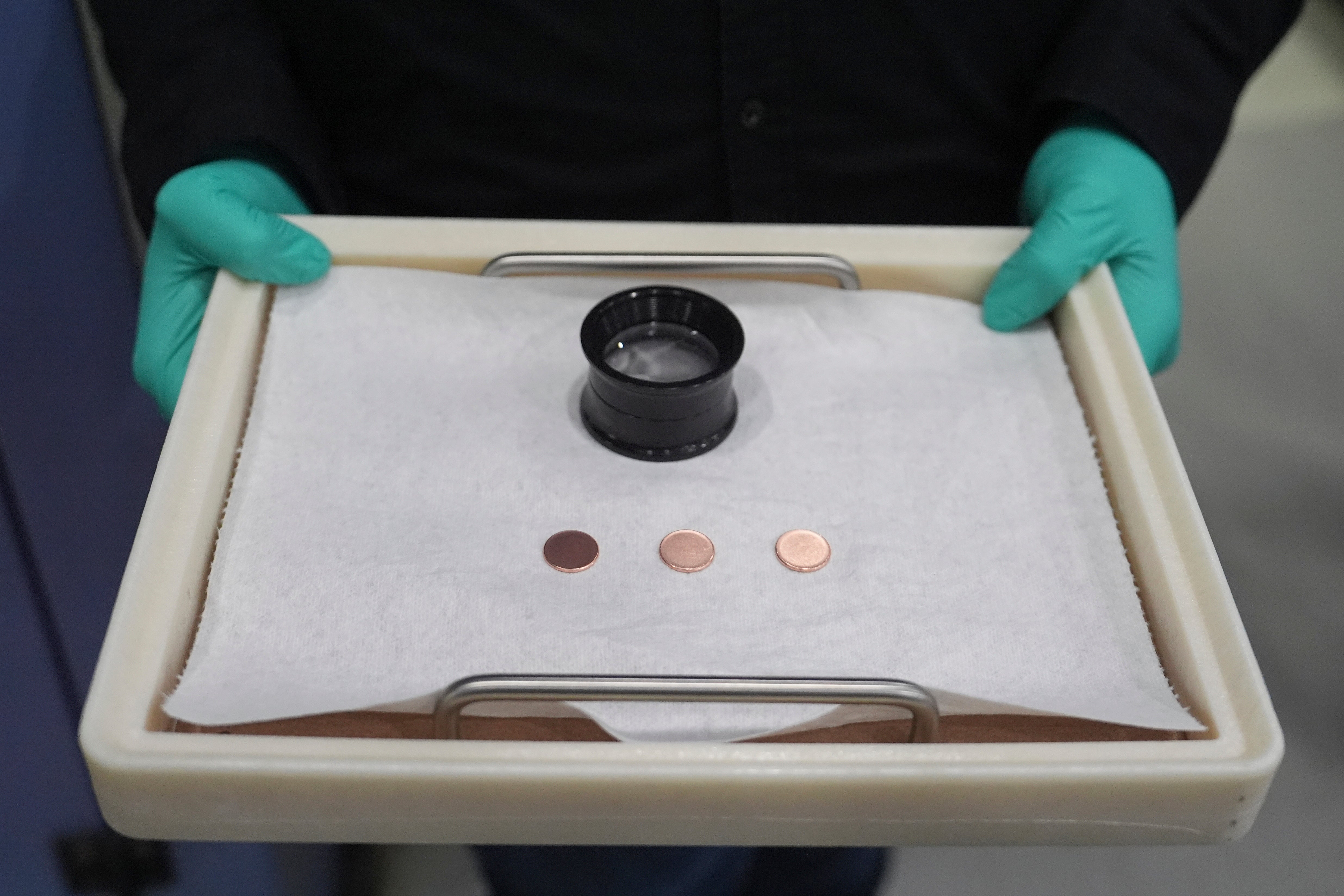 FILE - Blank coins wait to be the last pennies pressed at the U.S. Mint, in Philadelphia, Nov. 12, 2025