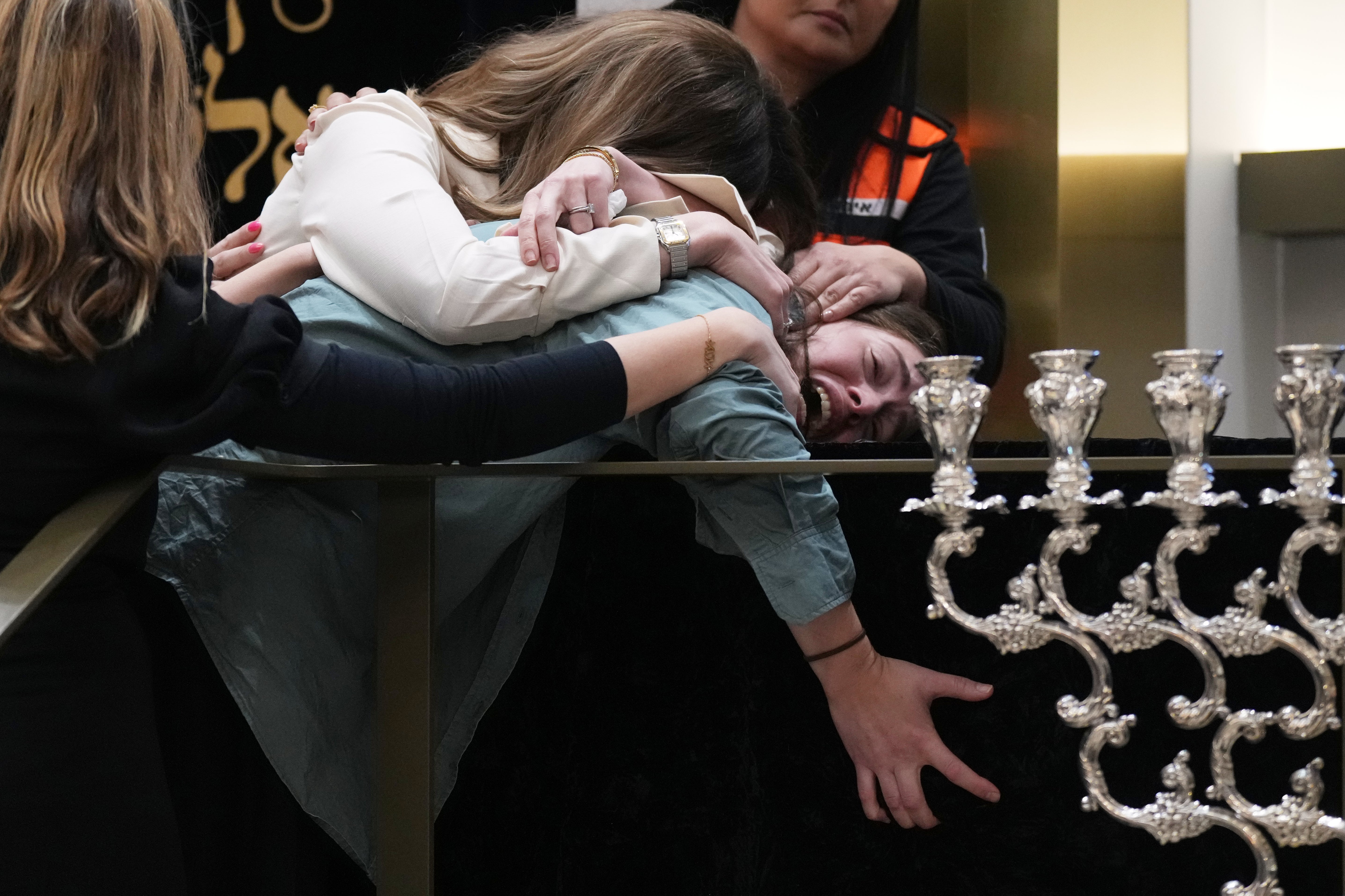 <p>Family members react at the coffin of Rabbi Eli Schlanger, a victim in the Bondi Beach mass shooting, during his funeral at a synagogue in Bondi on Wednesday, 17 December 2025, in Sydney, Australia</p>