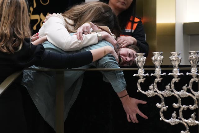 <p>Family members react at the coffin of Rabbi Eli Schlanger, a victim in the Bondi Beach mass shooting, during his funeral at a synagogue in Bondi on Wednesday</p>
