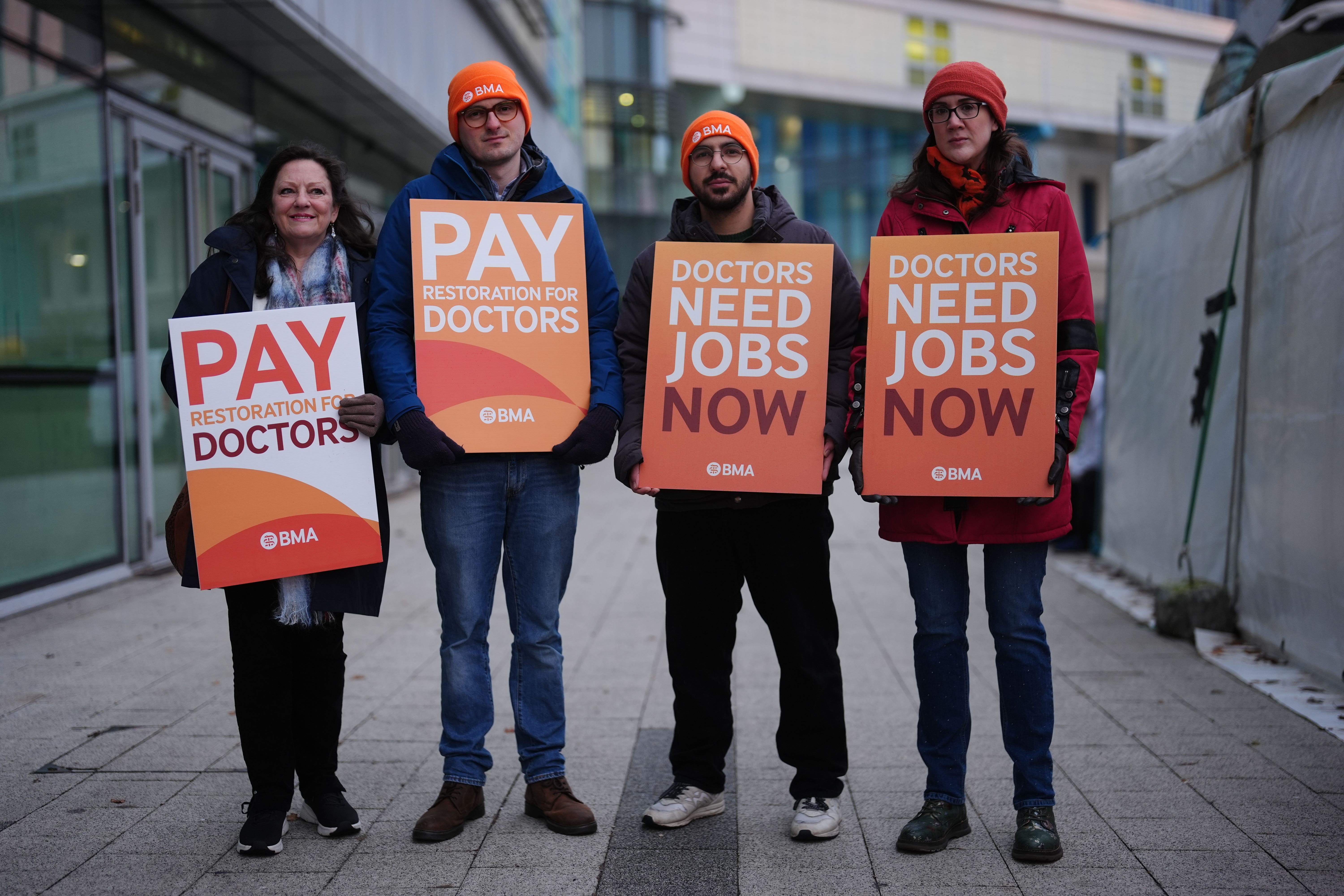 Resident doctors on the picket line outside Queen Elizabeth Hospital (PA)
