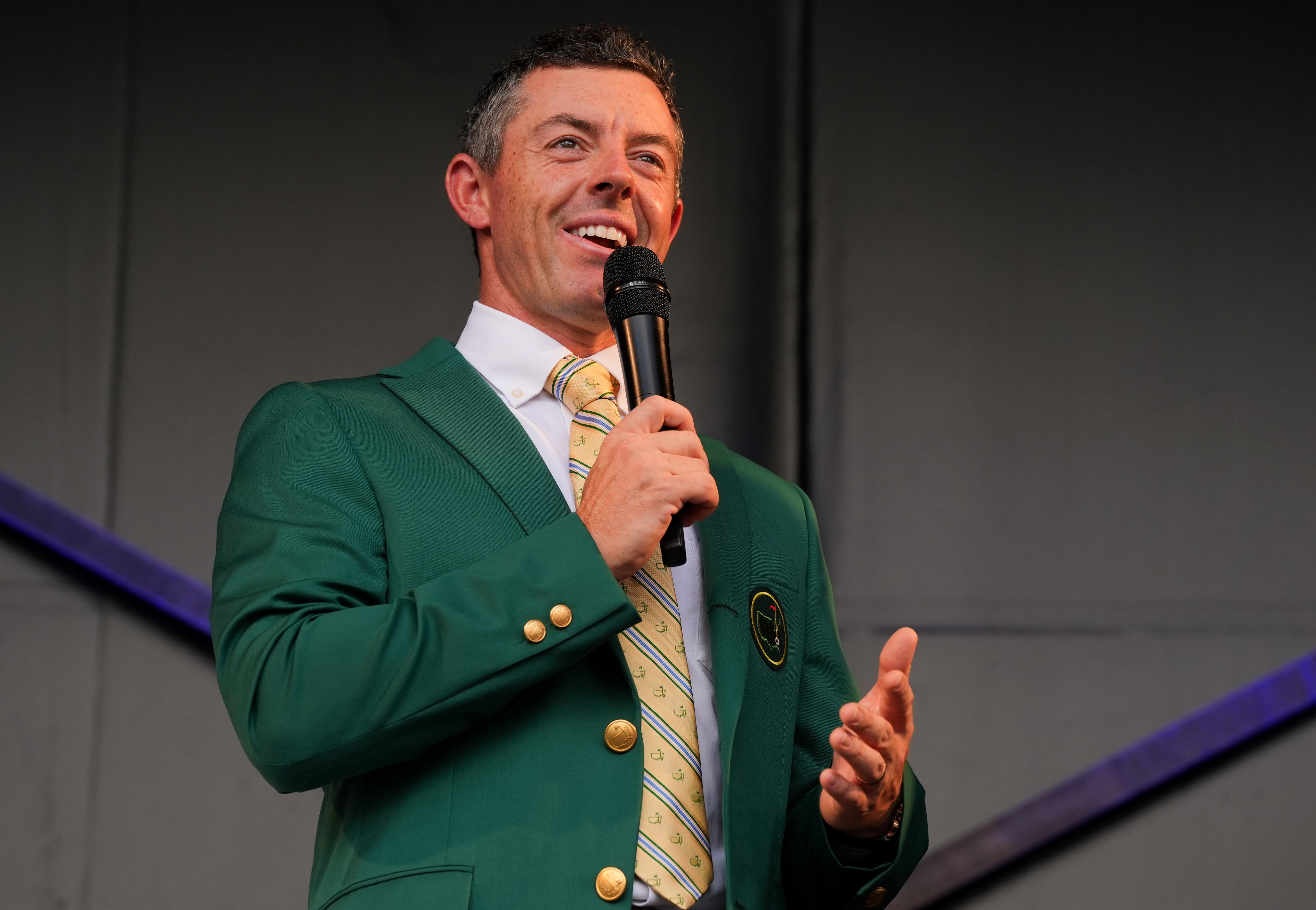 Rory McIlroy, sporting his Green Masters Jacket, speaks to the crowd