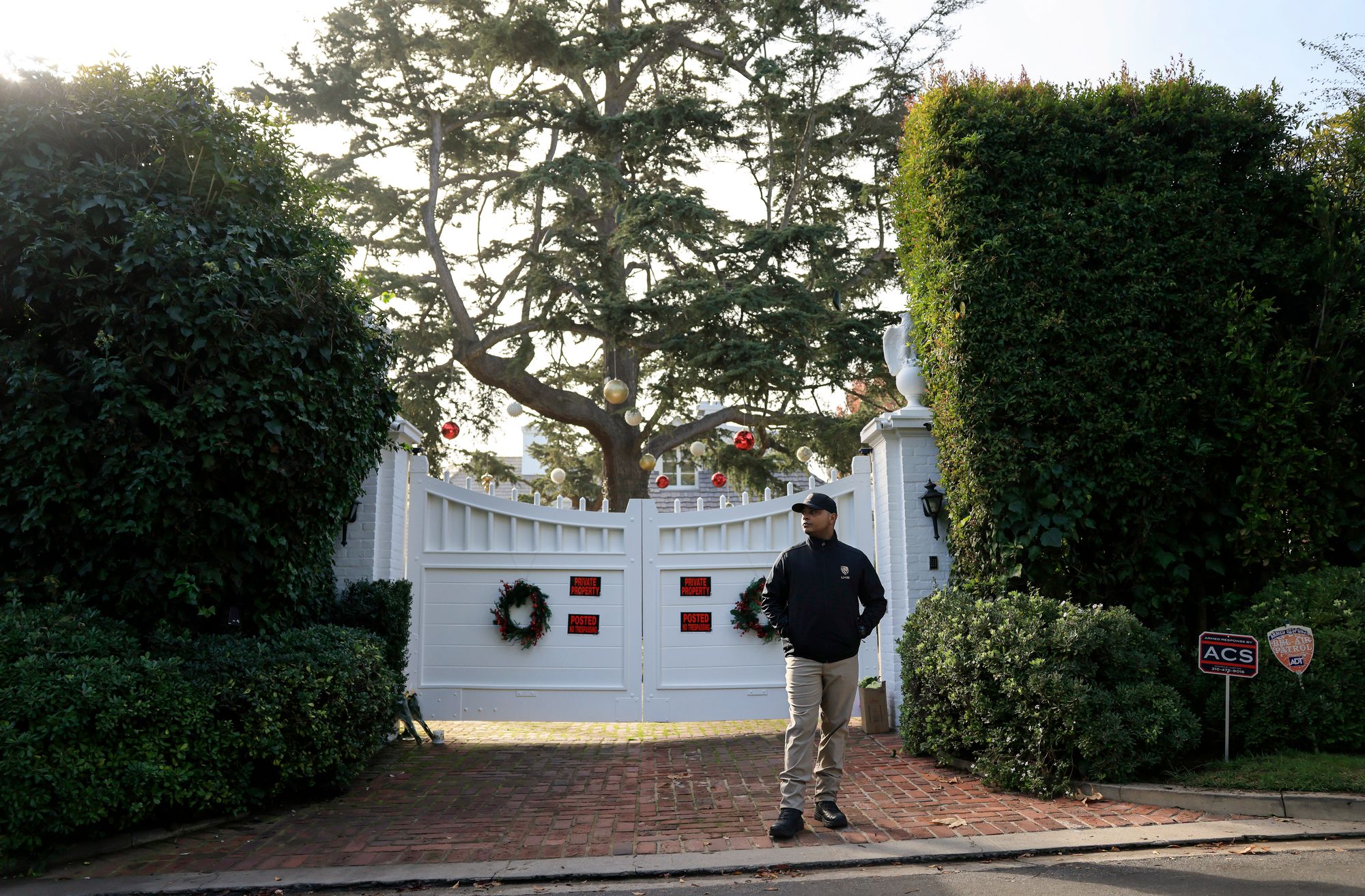 A security guard stands out the gate to the Reiners' Los Angeles home. Their daughter, Romy Reiner, who lived opposite her parents, walked into the home and discovered her father’s body