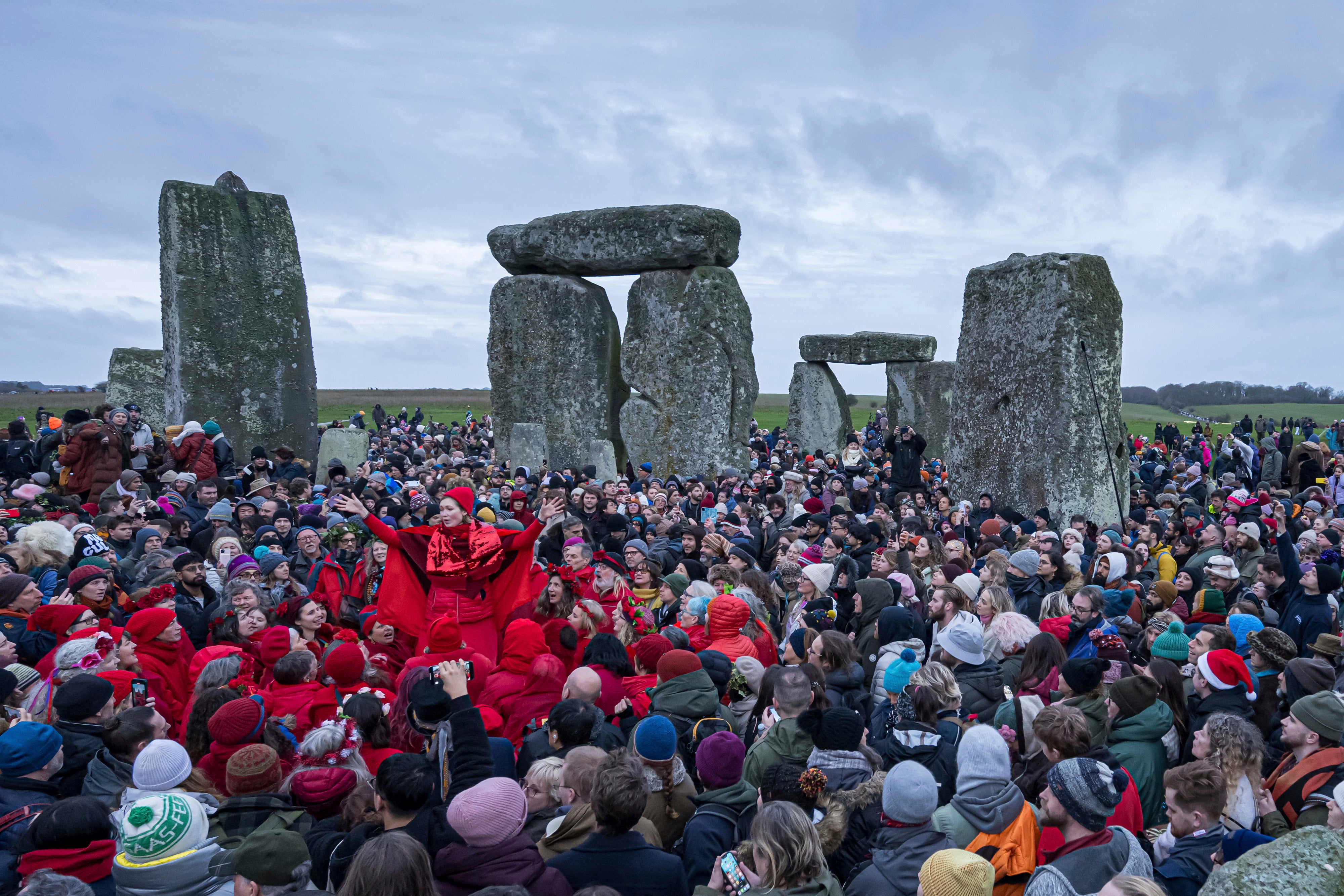 <p>People celebrate the Winter Solstice sunrise celebrations at Stonehenge, England, Saturday, Dec. 21, 2024.</p>