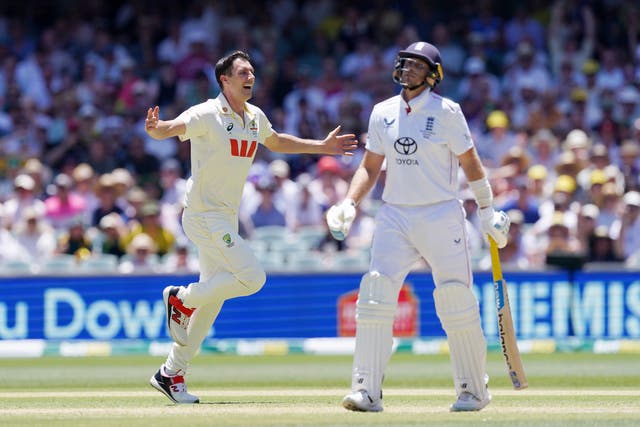 Australia’s Pat Cummins, left, celebrates taking the wicket of England’s Joe Root (Robbie Stephenson/PA)