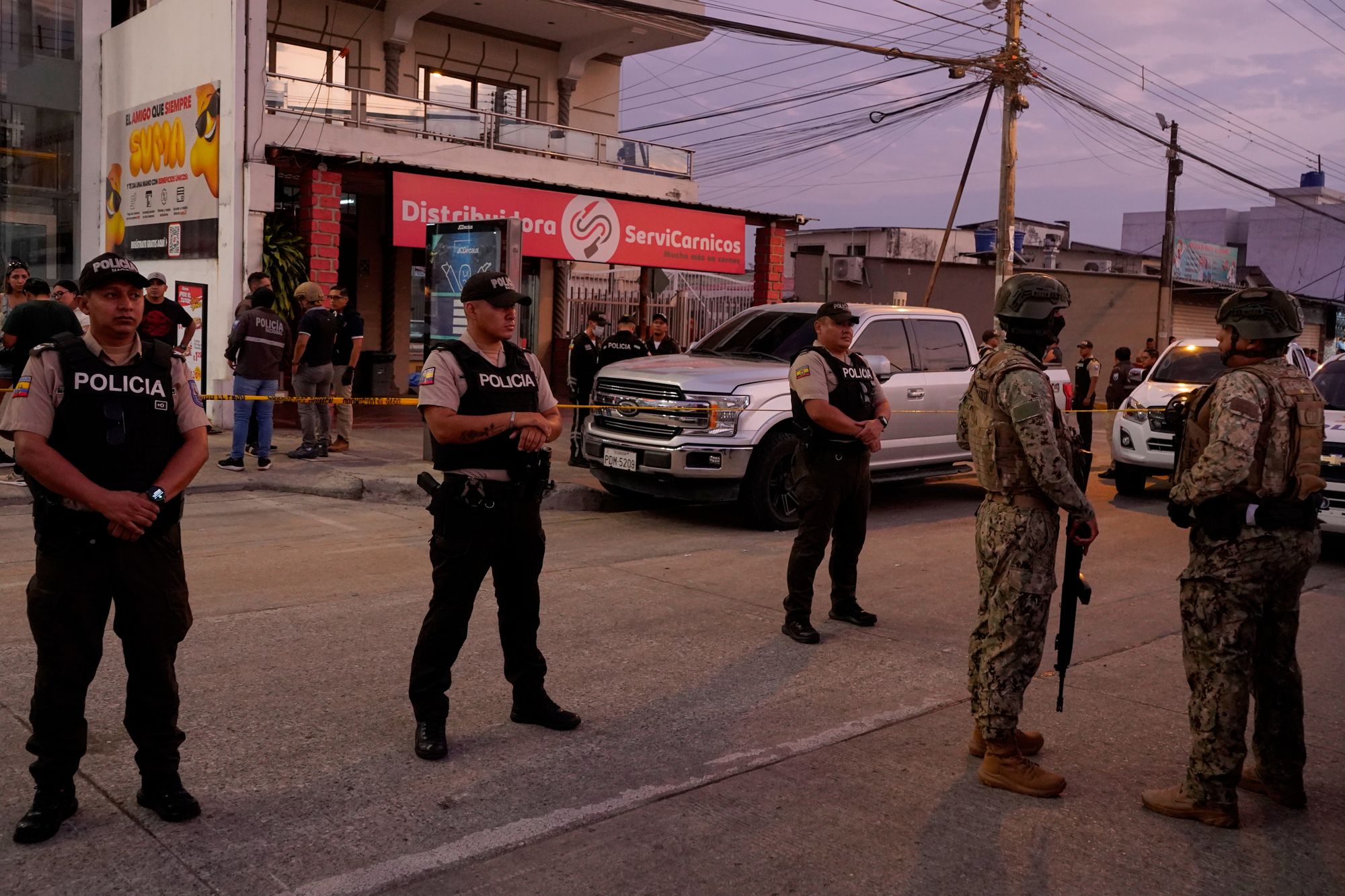 Police stand guard following the shooting of Mario Pineida