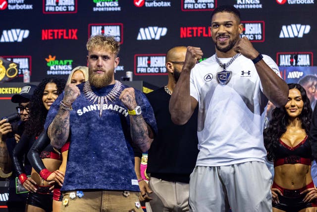 <p>Jake Paul and Anthony Joshua face each during a press conference </p>