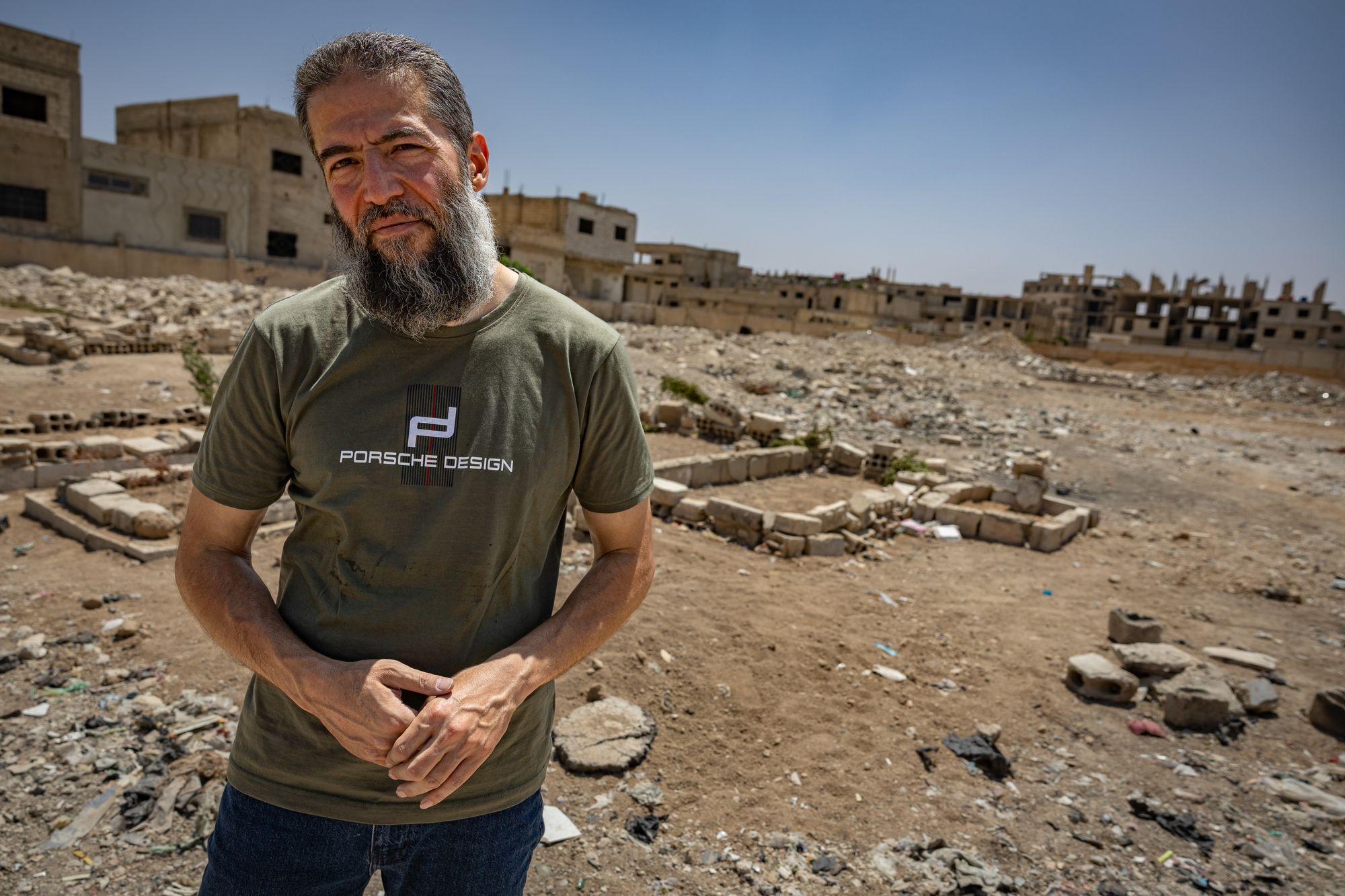 Fouad, who was disappeared for 21 years in Assad's prisons, beside a mass grave