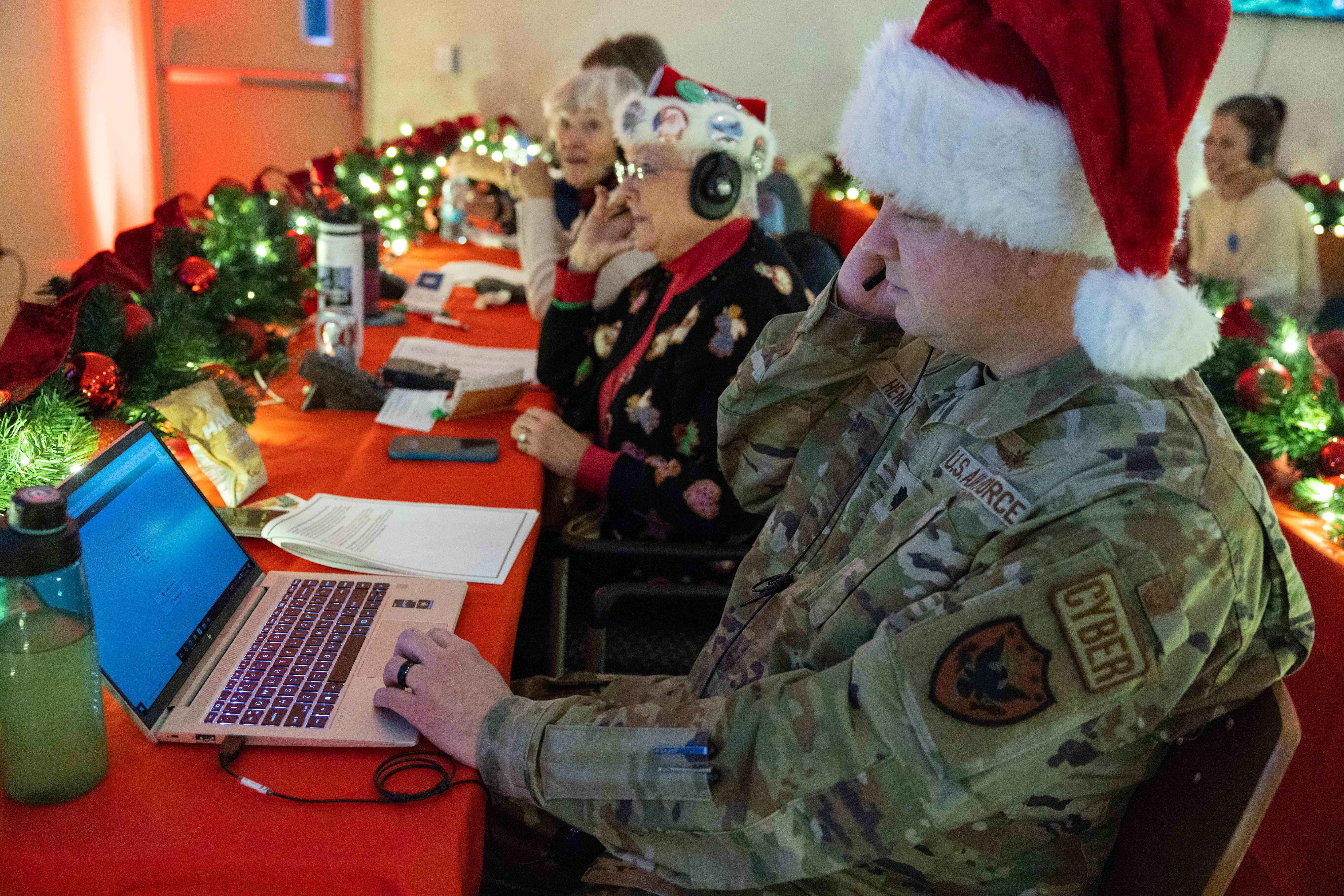 Volunteers take phone calls from children asking where Santa is and when he will deliver presents to their house, during the annual NORAD Tracks Santa Operation