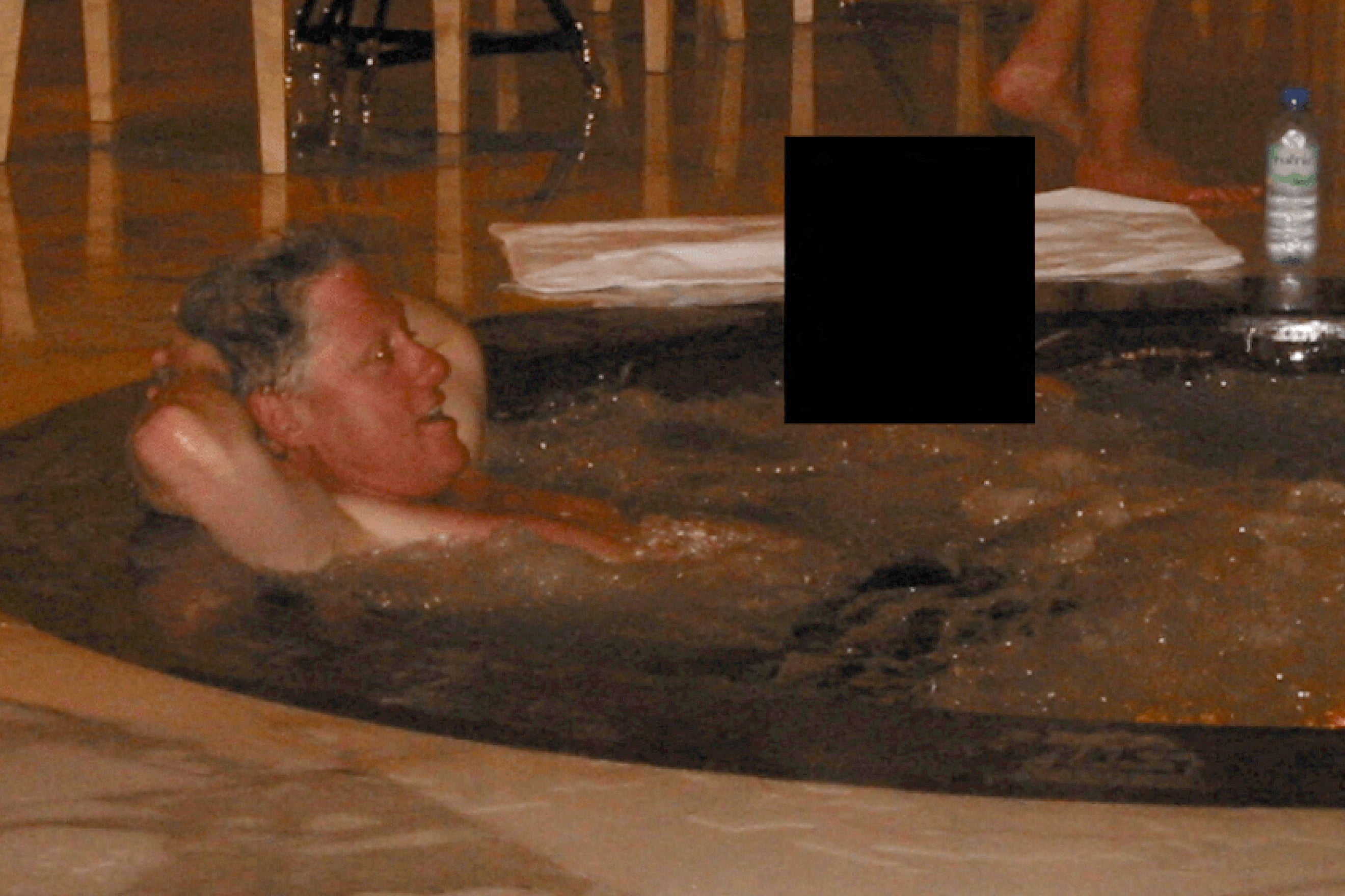 Clinton also is pictured in a hot tub with Maxwell and a woman whose face is redacted