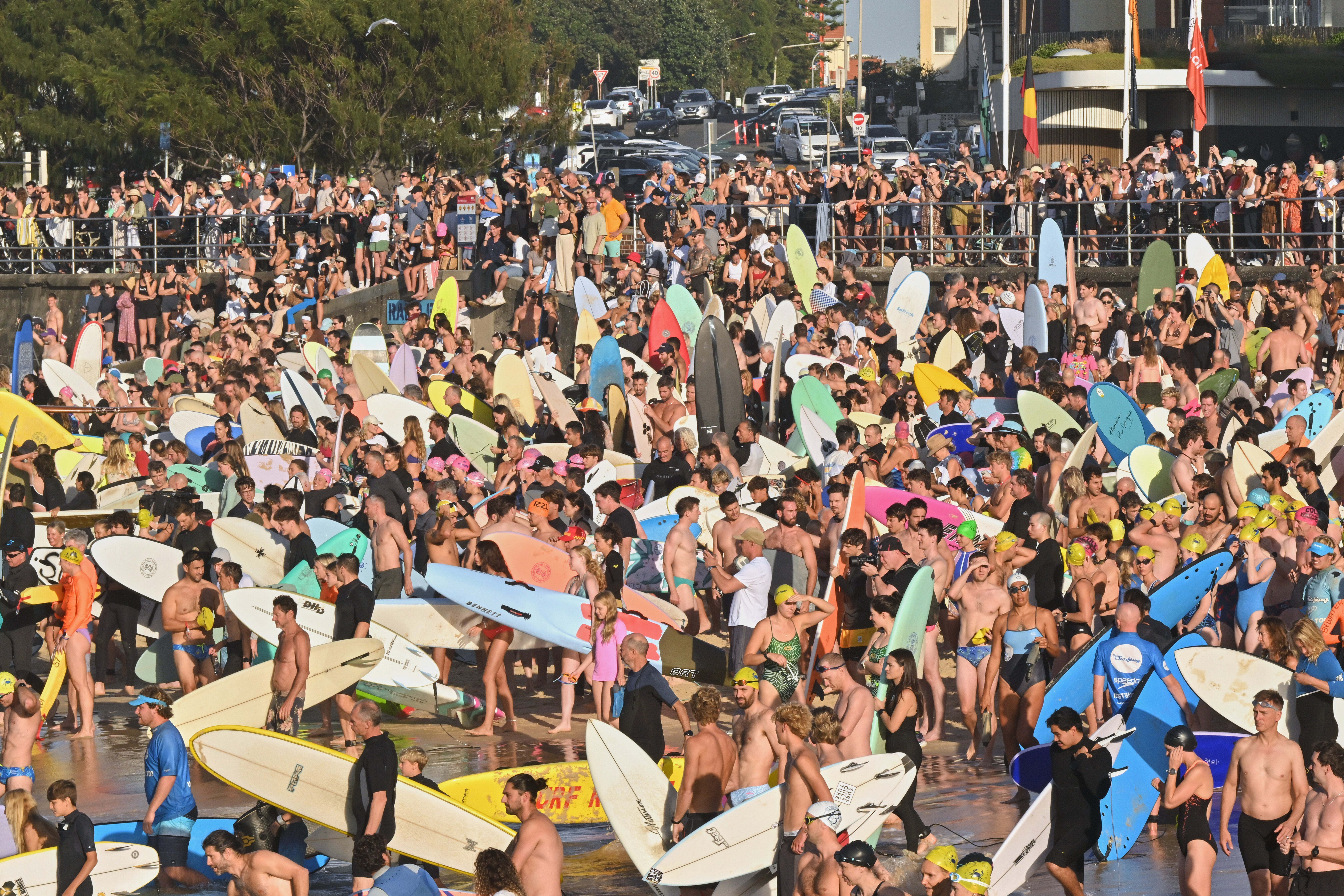 Surfers and swimmers prepare to swim out for a tribute at Bondi Beach, in Sydney, Friday, 19 December 2025, following last Sunday's shooting