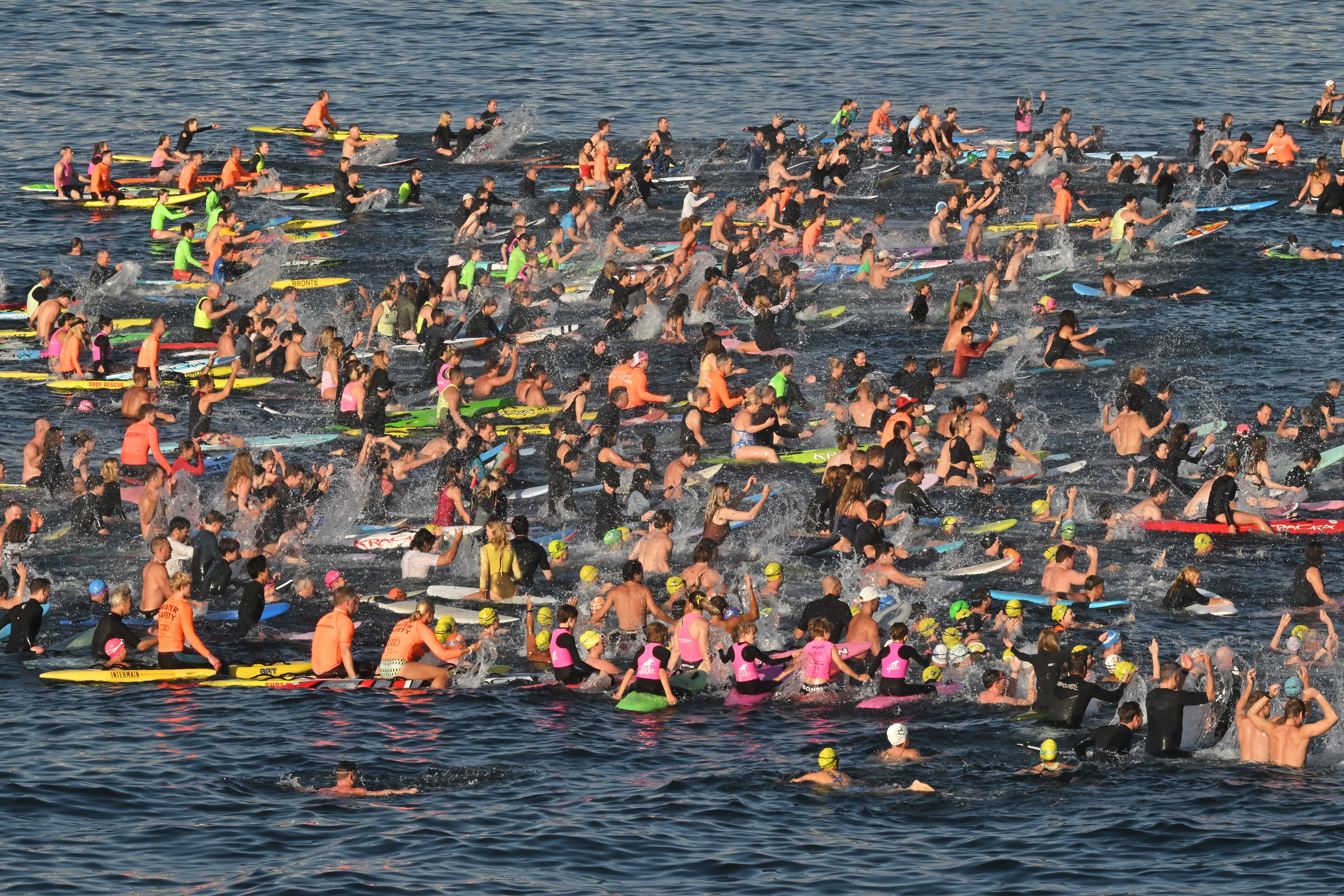 Surfers and swimmers hold a tribute in the sea at Bondi Beach, in Sydney, Friday, 19 December 2025