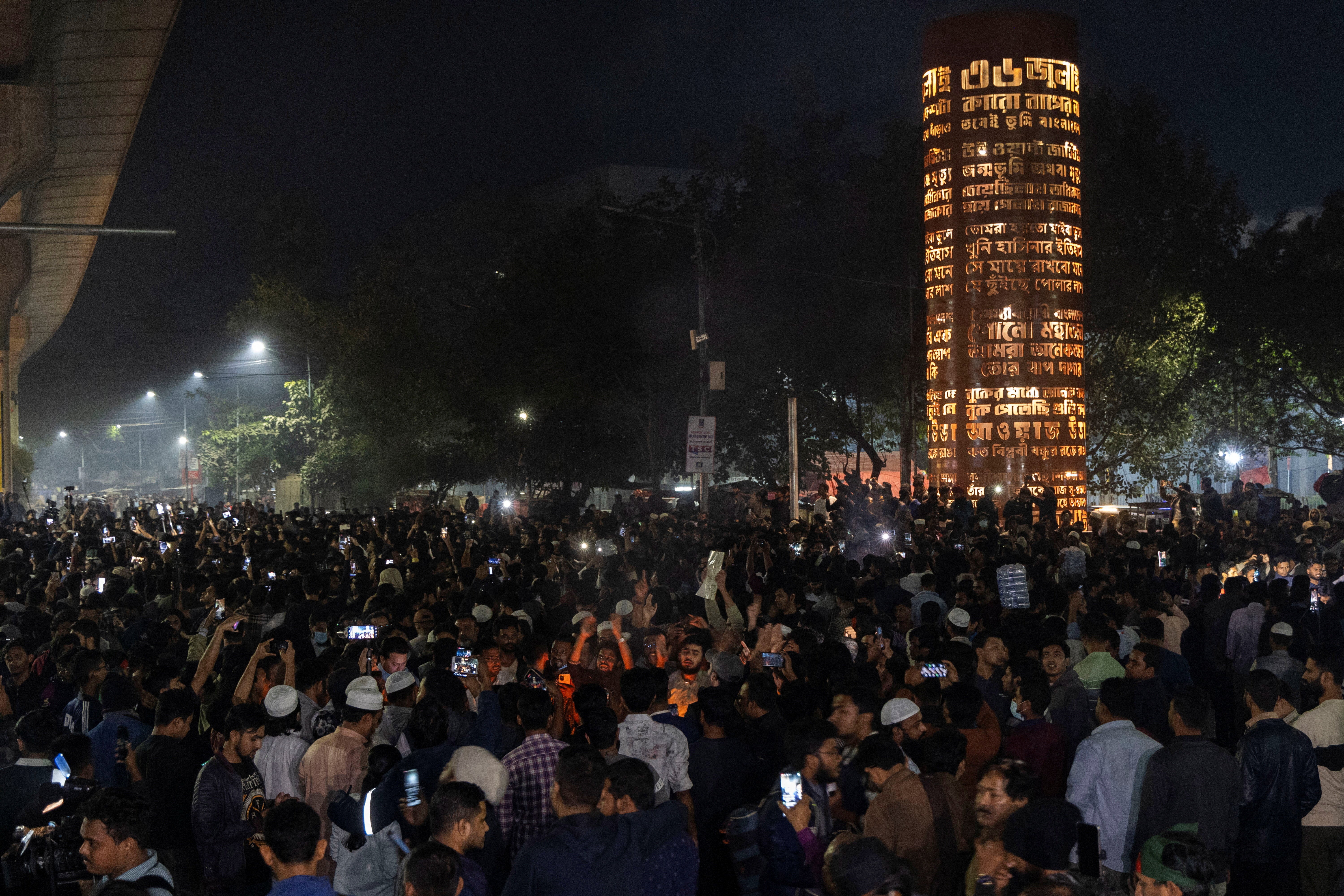 People gather following the death of Sharif Osman Hadi, in Dhaka