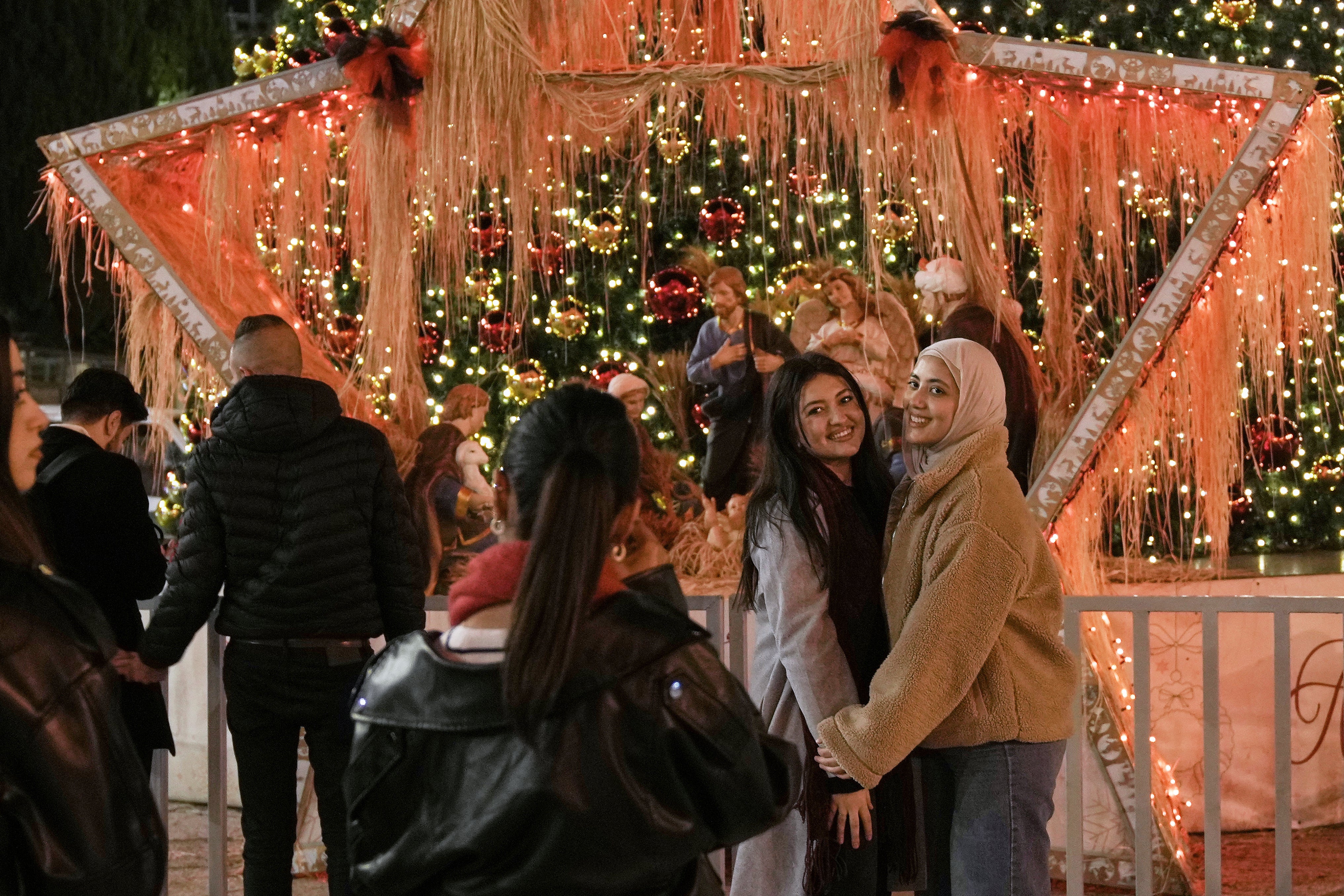 <p>People pose for a picture in Manger Square in the West Bank city of Bethlehem, Tuesday, Dec. 16, 2025. (AP Photo/Mahmoud Illean)</p>