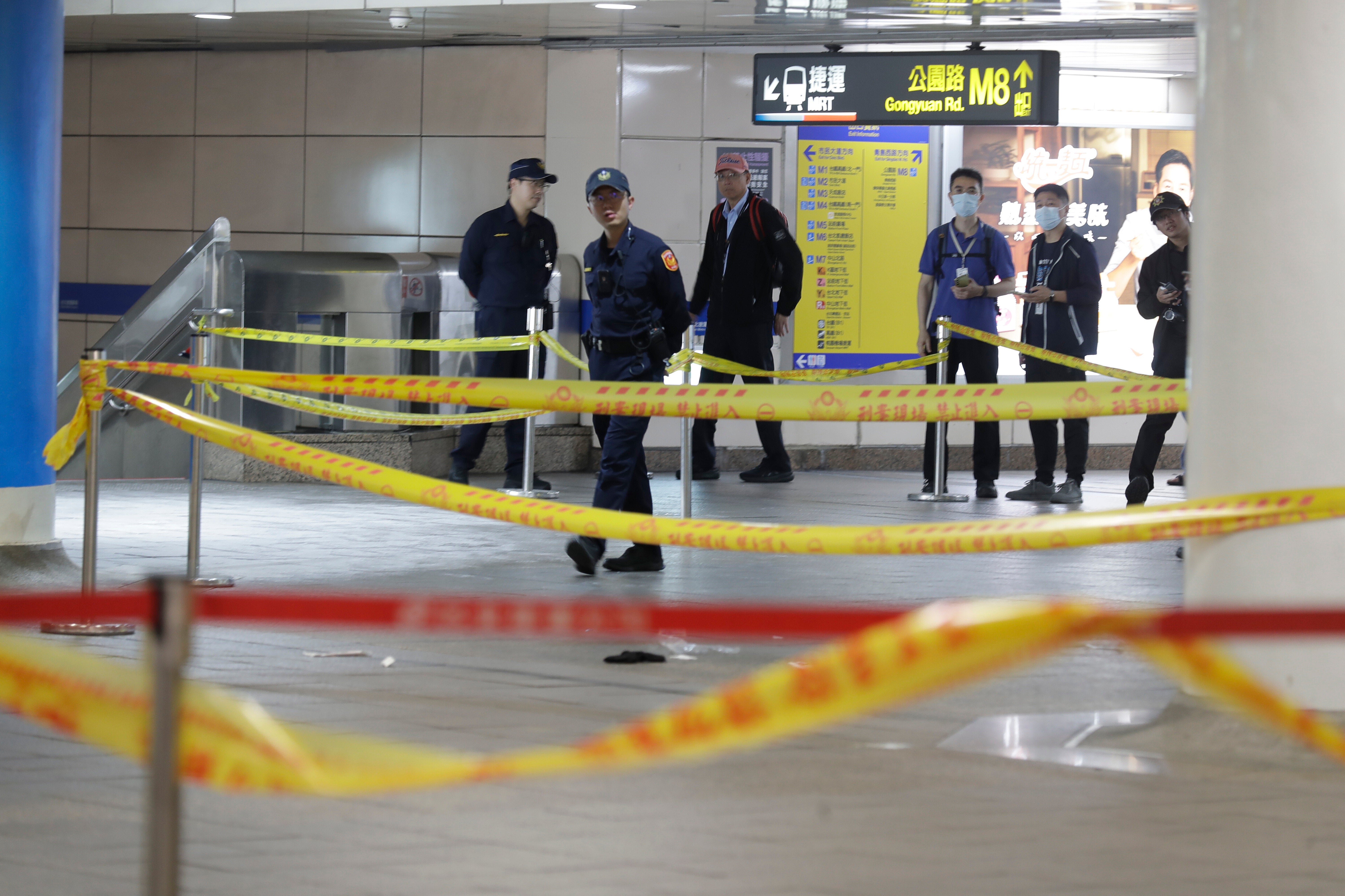 Taiwan police cordoned off the scene after a knife attack in Taipei, Taiwan, Friday, Dec. 19, 2025. (AP Photo/Chiang Ying-ying)