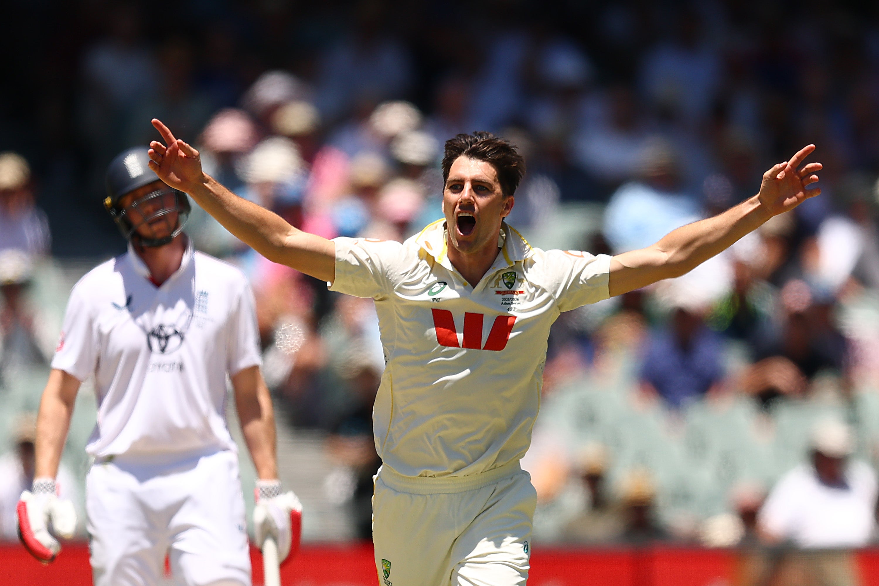 Pat Cummins of Australia celebrates taking the wicket of Ollie Pope