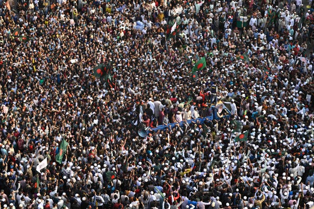 <p>Protesters shout slogans and block an intersection following overnight attacks and vandalism after the death of activist Sharif Osman Hadi, who was shot by an assailant a week ago, in Dhaka, Bangladesh (AP Photo/Mahmud Hossain Opu)</p>