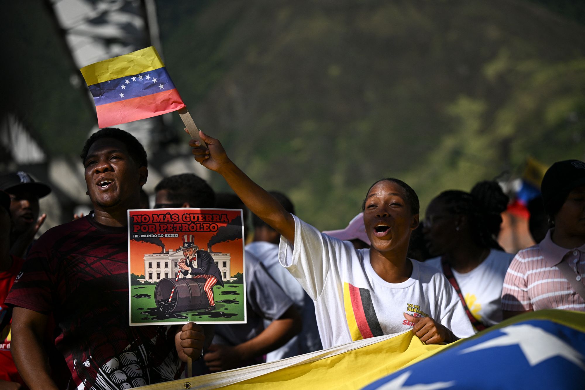 <p>Supporters of Venezuelan President Nicolas Maduro take part in a rally against US military activity in the Caribbean, at the San Jose community in the Petare neighborhood in Caracas on December 13, 2025</p>