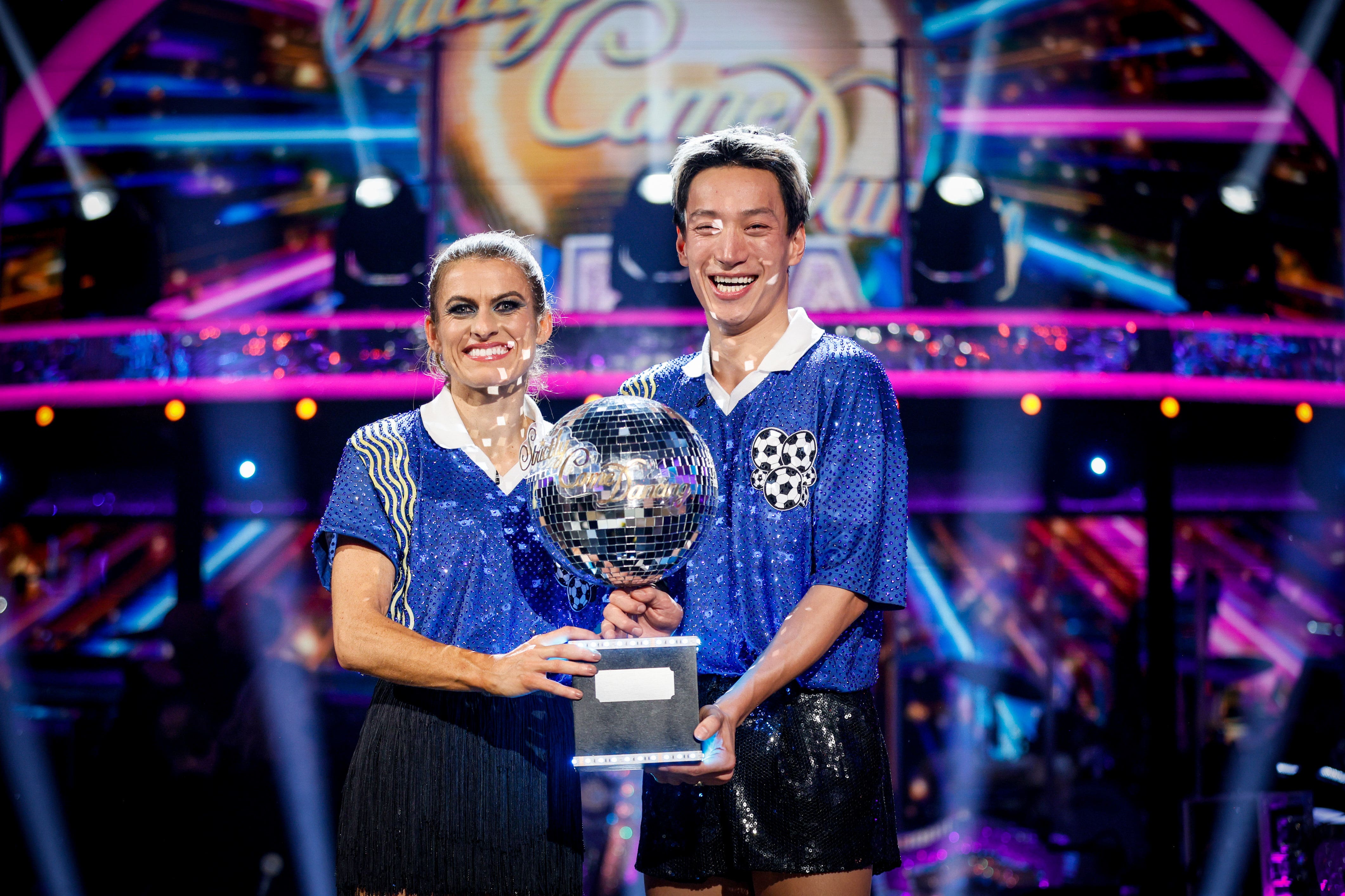 Karen Carney and Carlos Gu with their trophy after winning the 2025 series of Strictly Come Dancing (Guy Levy/BBC/PA)