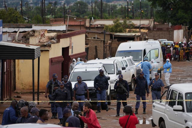 <p>South African police gather at the scene of a mass shooting where gunmen killed nine and injured at least 10 in a pub in Bekkersdal, South Africa, Sunday, Dec. 21, 2025</p>