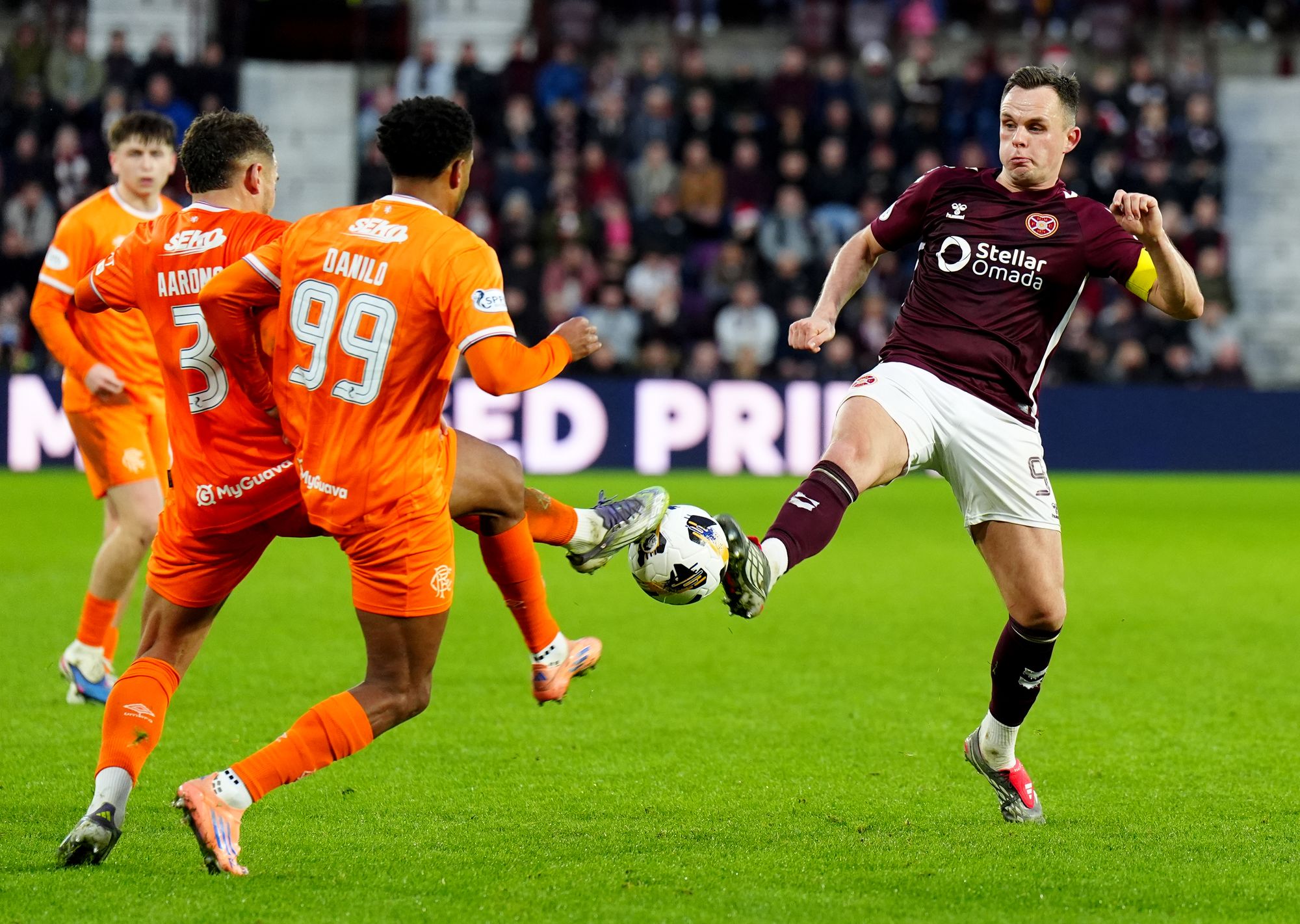 Lawrence Shankland (right) battles for the ball with Rangers’ Max Aarons (left) and Danilo