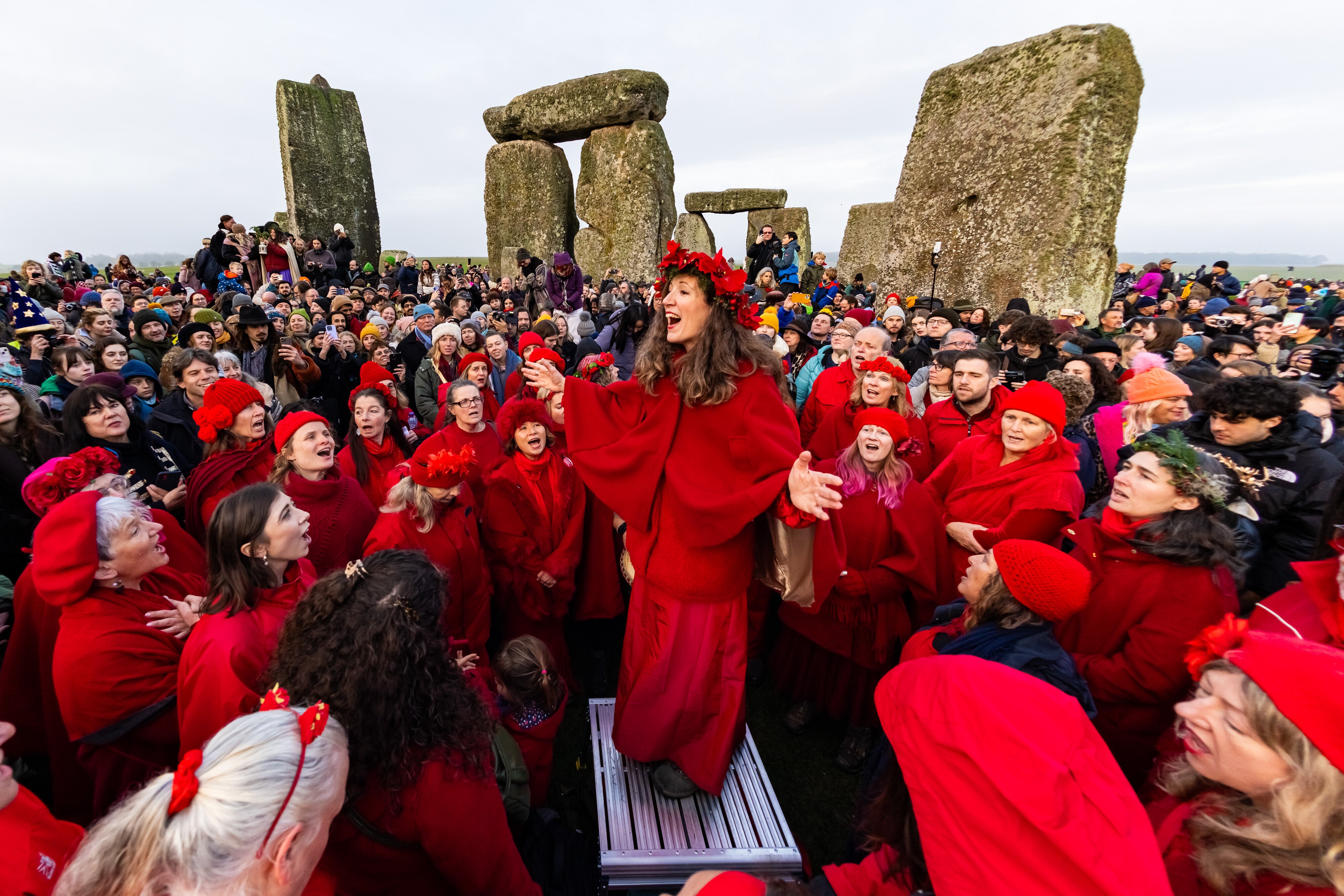 People celebrate the Winter Solstice sunrise celebrations at Stonehenge, a world-famous prehistoric monument on Salisbury Plain, England, Sunday, Dec. 21, 2025
