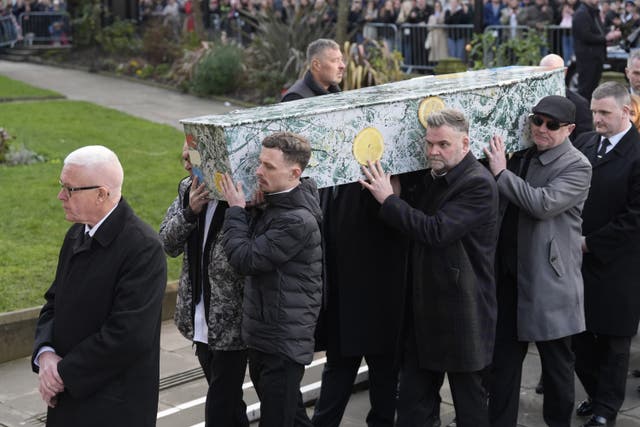 <p>The bearer party carry the coffin decorated with the artwork ‘Bye Bye, Badman’ painted by John Squire for the cover of The Stone Roses’ debut album</p>