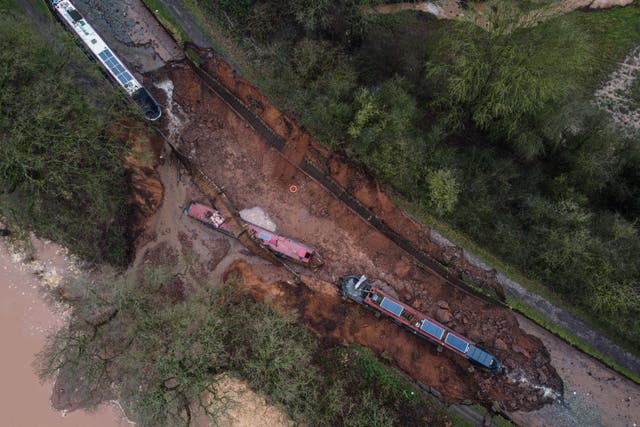 The scene in Whitchurch, Shropshire, where emergency services have declared a major incident after receiving reports at 4.22am this morning of a sinkhole causing large volumes of water to escape onto land in the Chemistry area of Whitchurch. Ten people have been helped to safety after a 50-metre-long sinkhole breached a canal in Shropshire, leaving several narrow boats stranded. Picture date: Monday December 22, 2025.