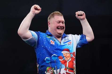 <p>Ricky Evans celebrates defeating seventh seed James Wade at the PDC World Championship</p>