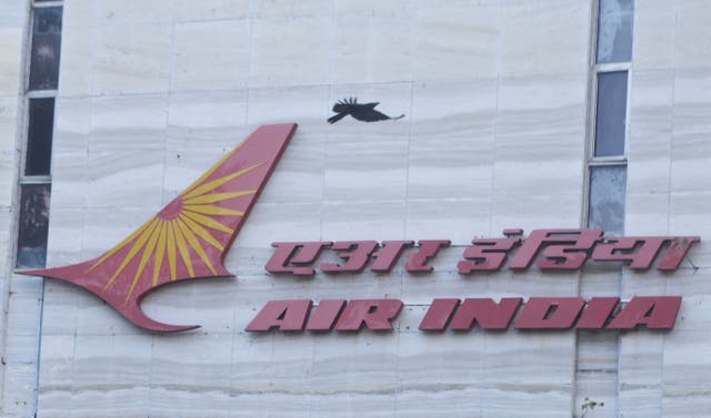 <p>A bird flies over a logo of Air India airlines at the corporate headquarters in Mumbai</p>