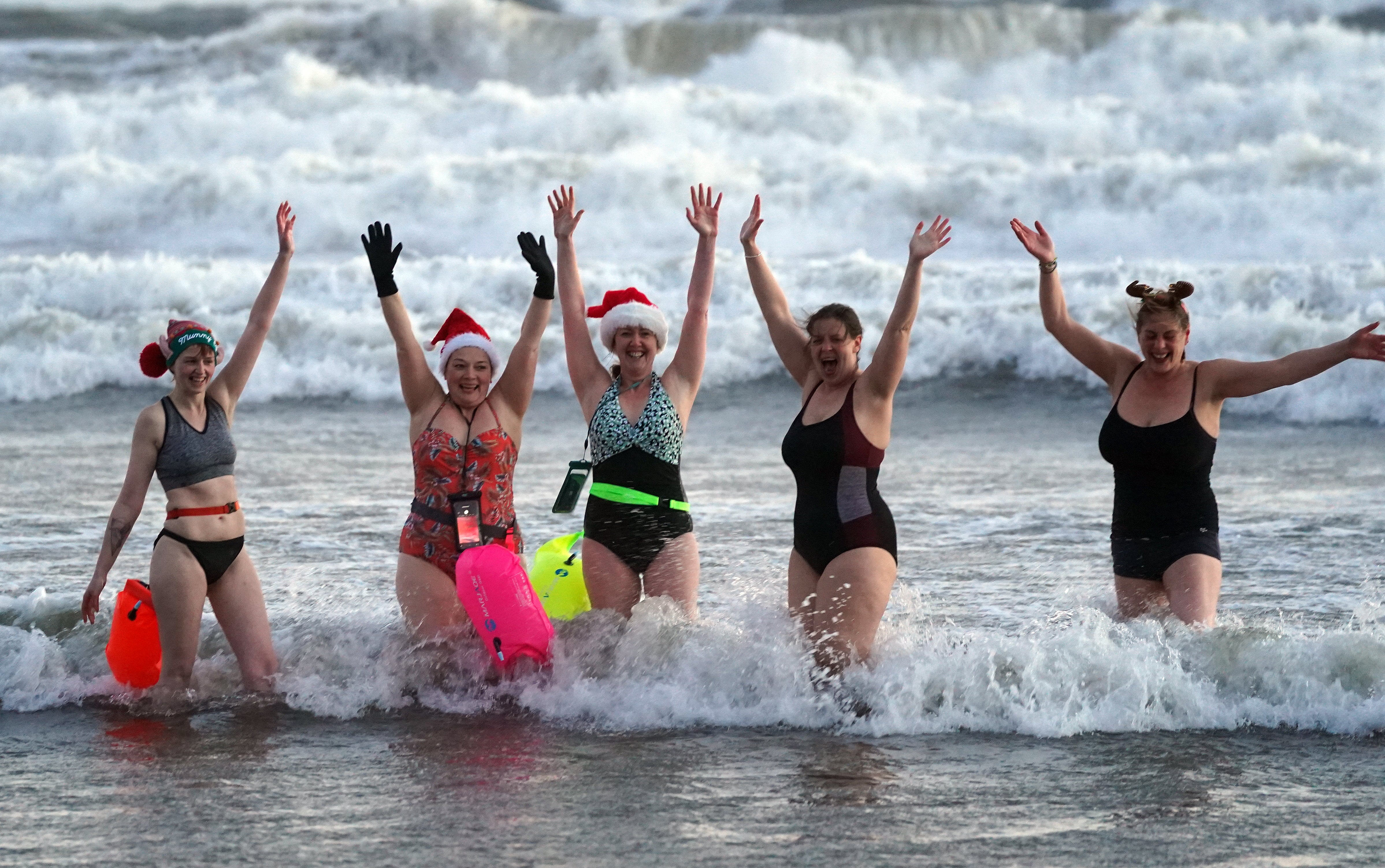 Swimmers on Christmas Day dip at Tynemouth beach, north-east England
