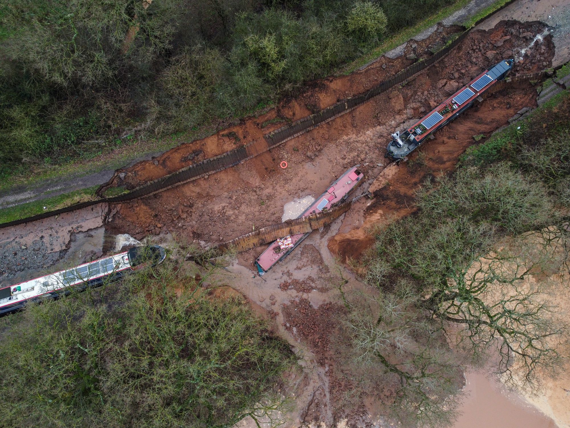Ten people were helped to safety after a 50m-long sinkhole breached a canal in Shropshire, leaving several narrow boats stranded