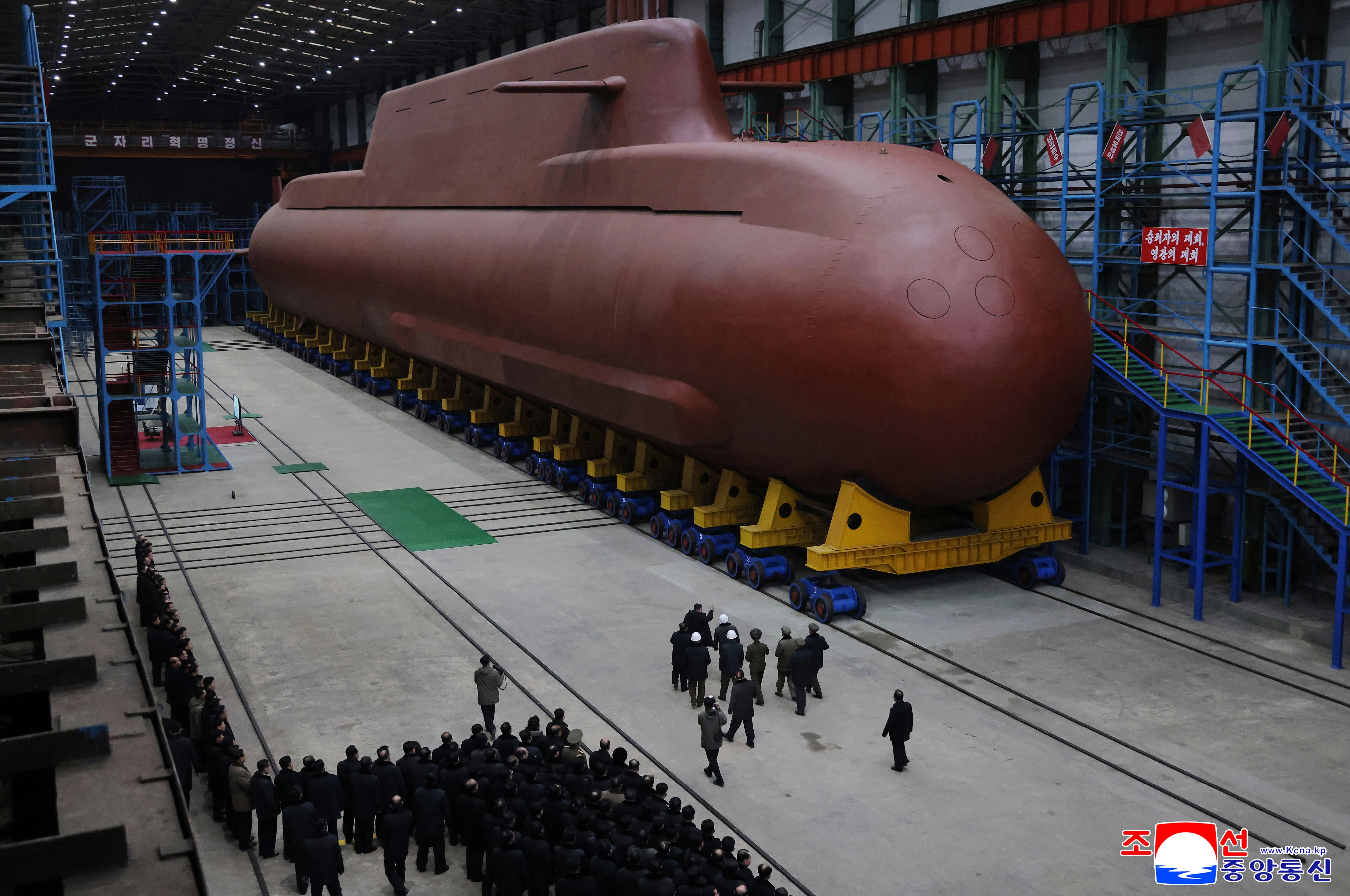 Kim Jong Un inspects a submarine under construction at an undisclosed location in North Korea