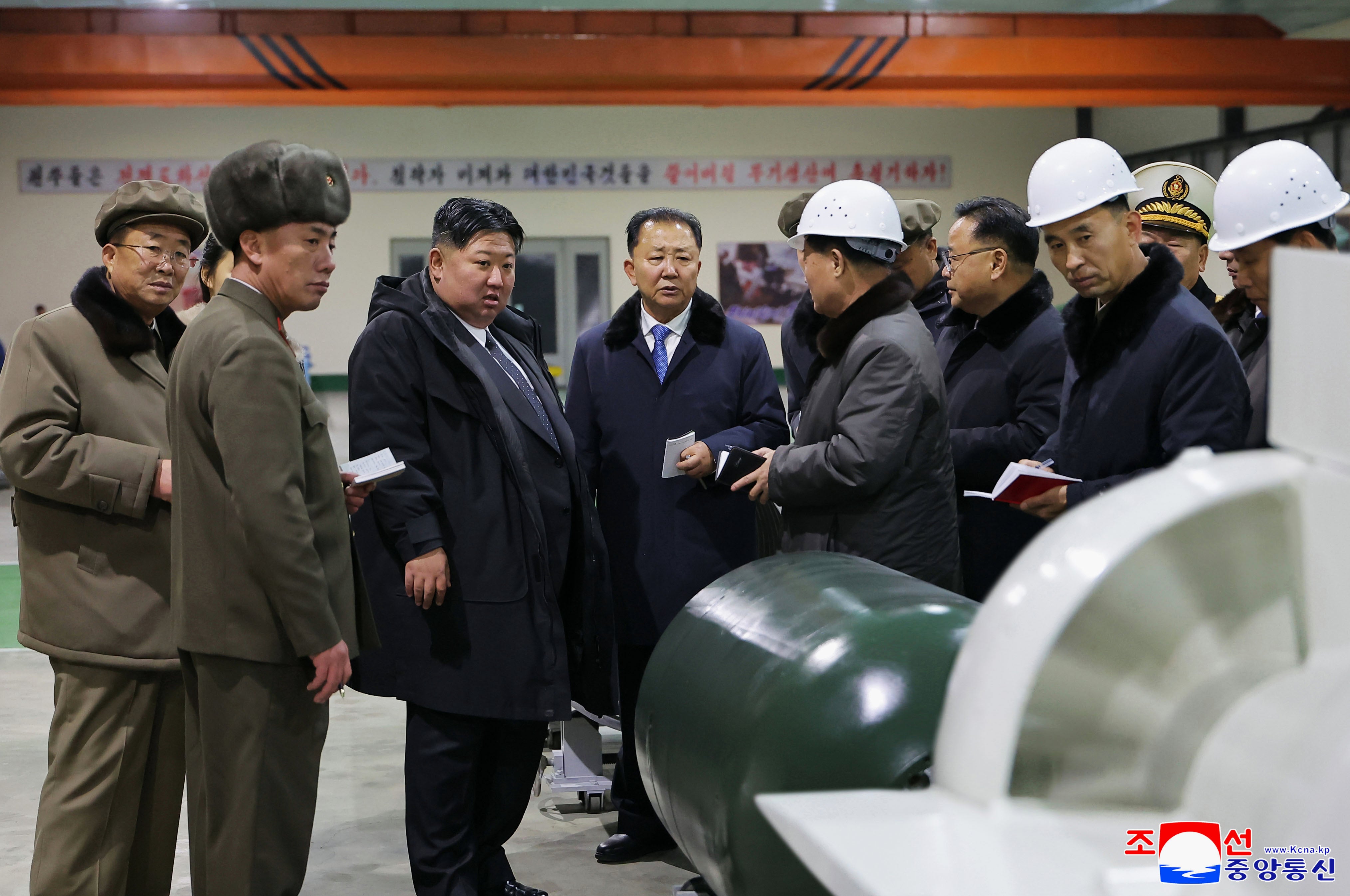 Kim Jong Un visits a shipyard as he inspects a nuclear-powered submarine under construction at an undisclosed location in North Korea
