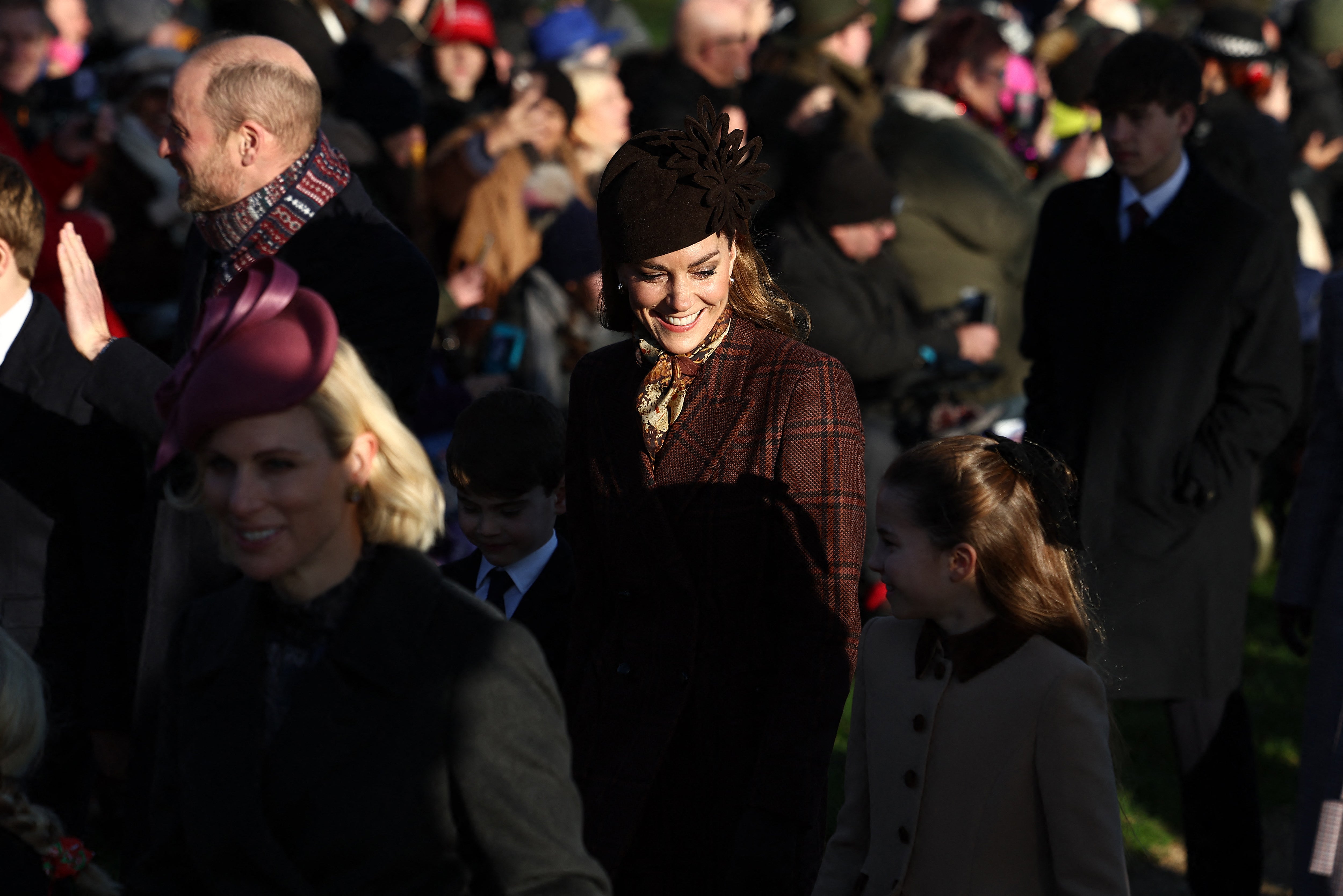 Catherine, Princess of Wales (C), holds hands with Prince Louis (I) and Princess Charlotte
