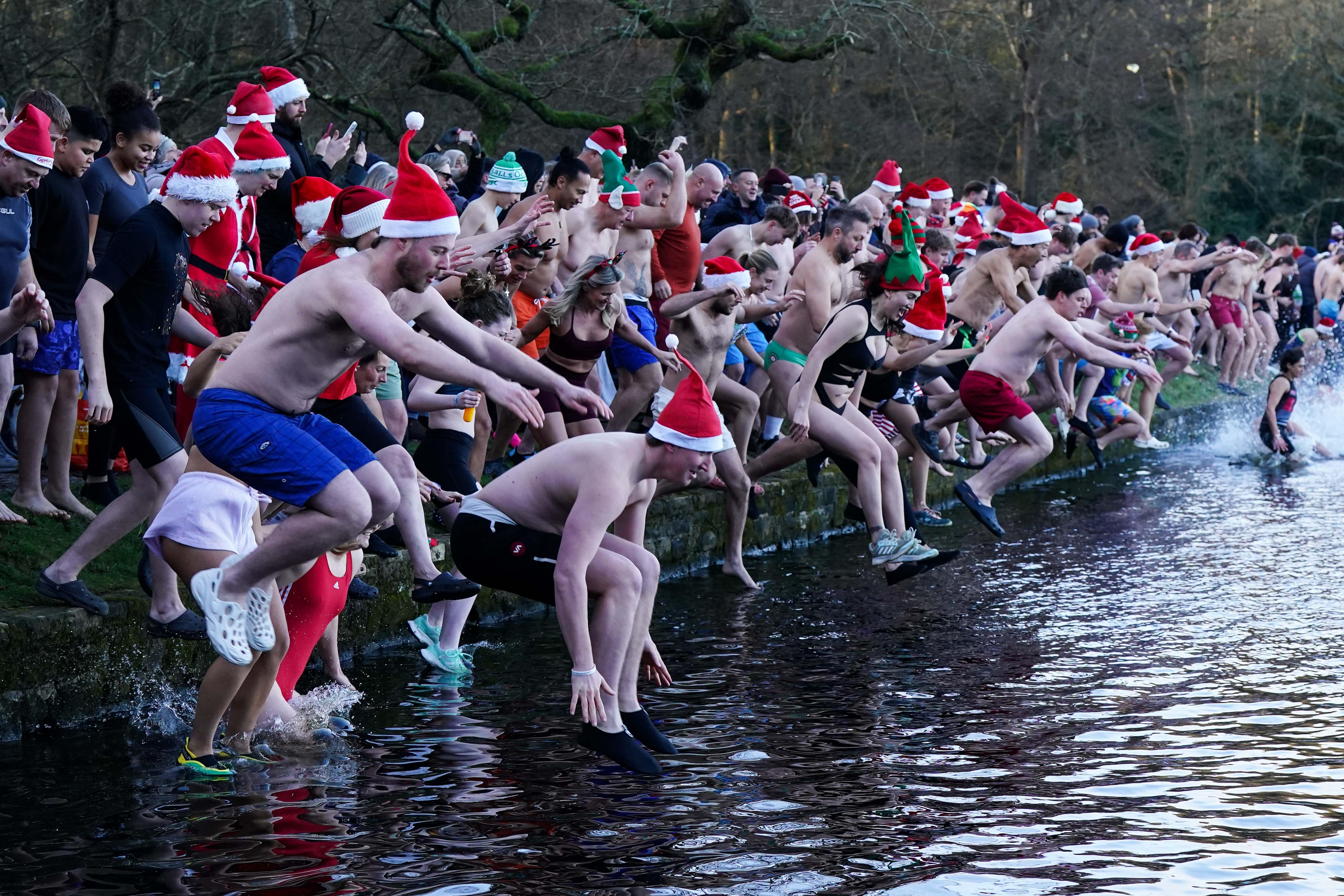 Swimmers take a Christmas Day dip in Blackroot Pool at Sutton Park, in Sutton Coldfield, Birmingham (Jacob King/PA)