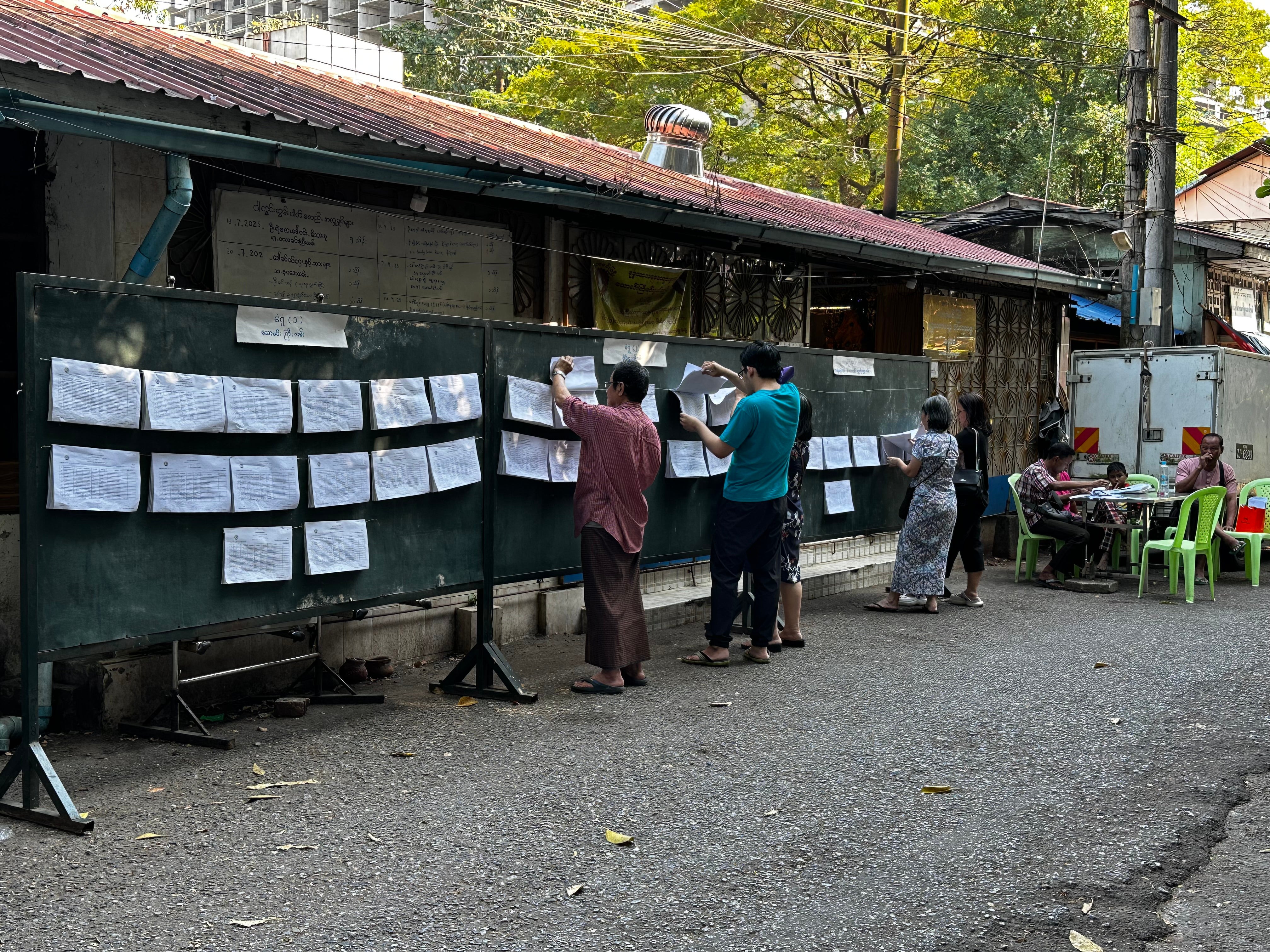 The electoral list displayed alongside a poster in Myanmar