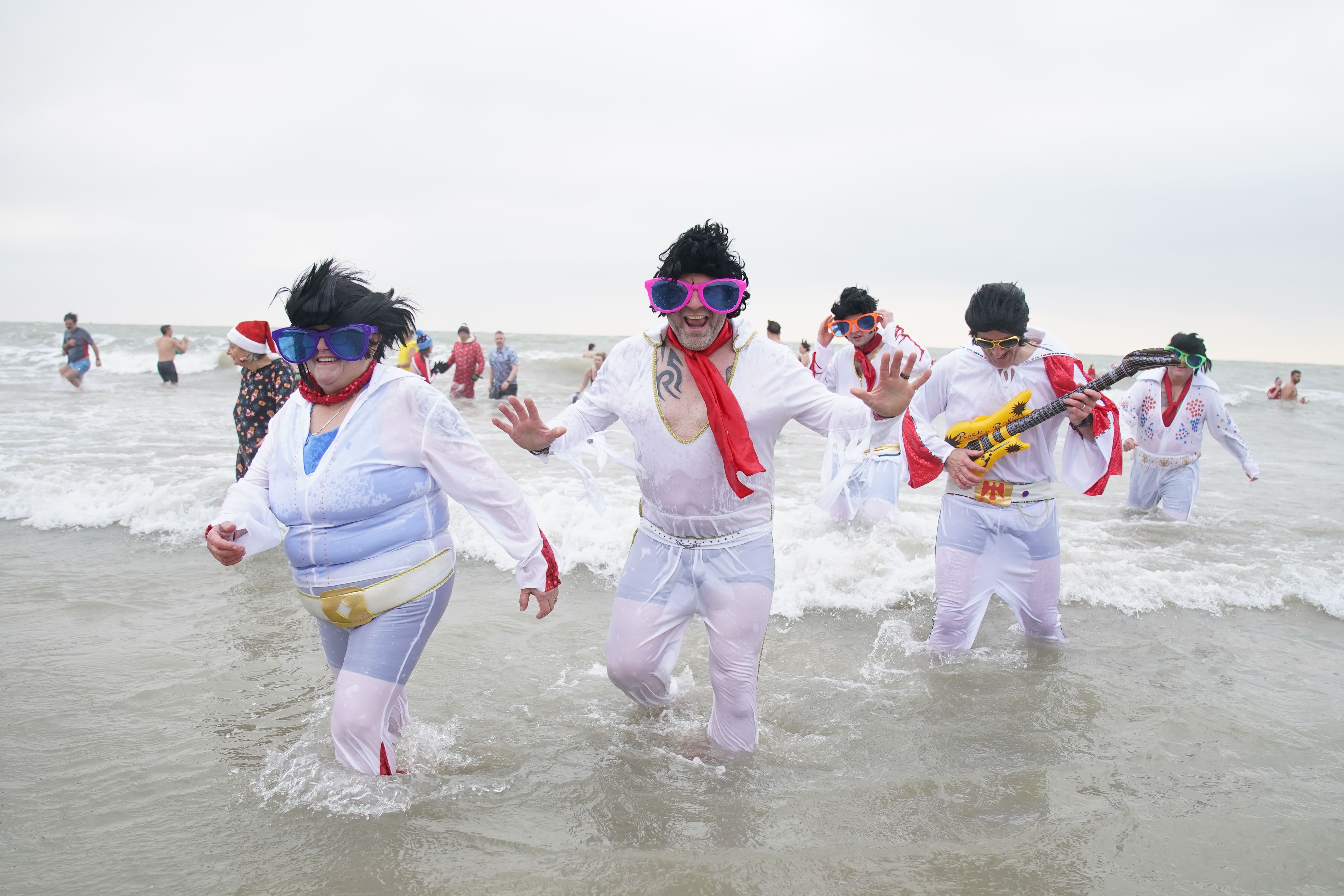 Swimmers dressed as Elvis take part in the Folkestone Lions’ Boxing Day Dip at Sunny Sands Beach in Folkestone (Gareth Fuller/PA)