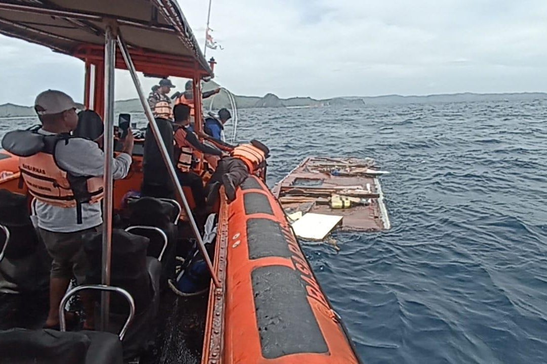 Rescuers examine debris believed to be a part of a tour boat that sank near Padar Island within Komodo National Park