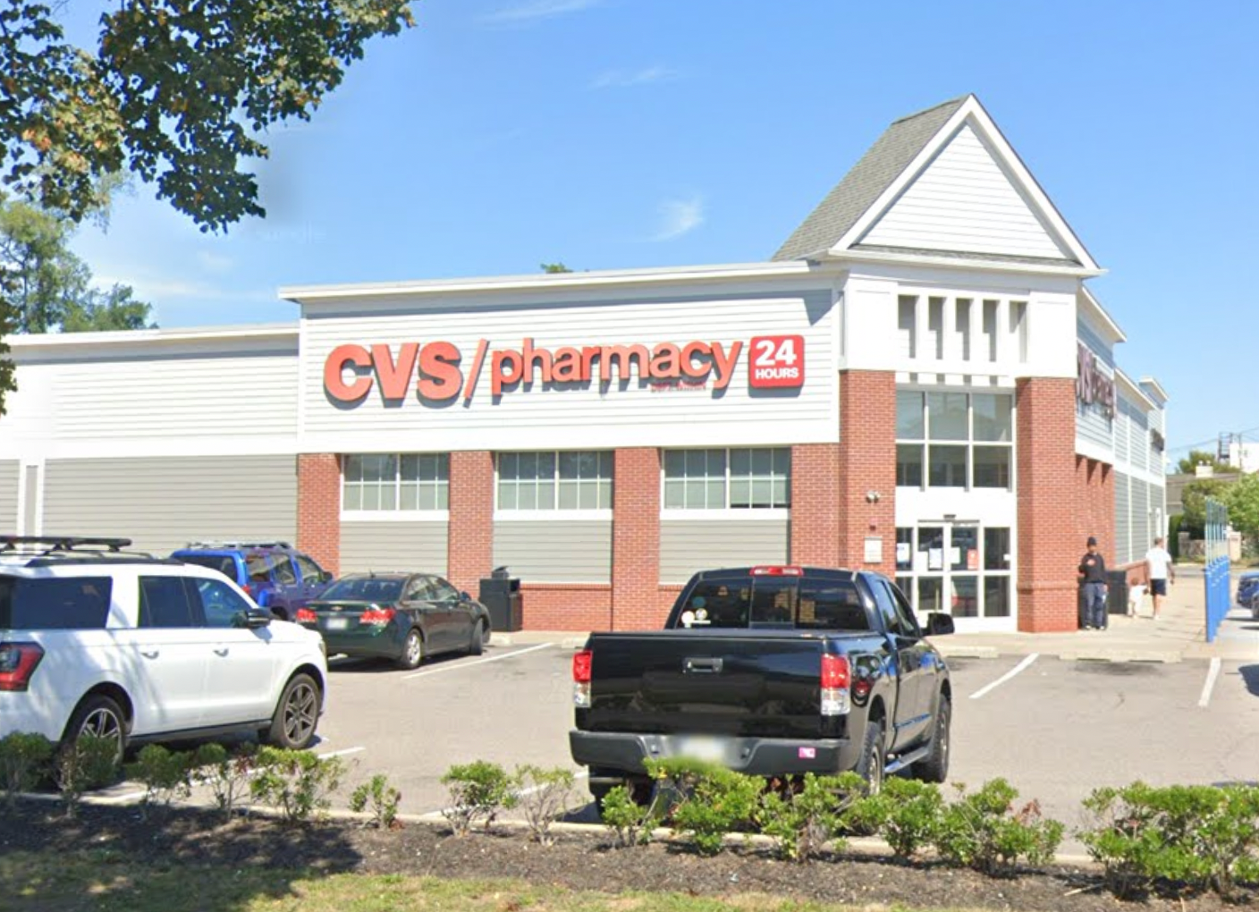 A makeshift memorial was set up outside the CVS store in Lindenhurst on Friday, where community members stopped to honor Edeedson Cine, who made a lasting impression on customers