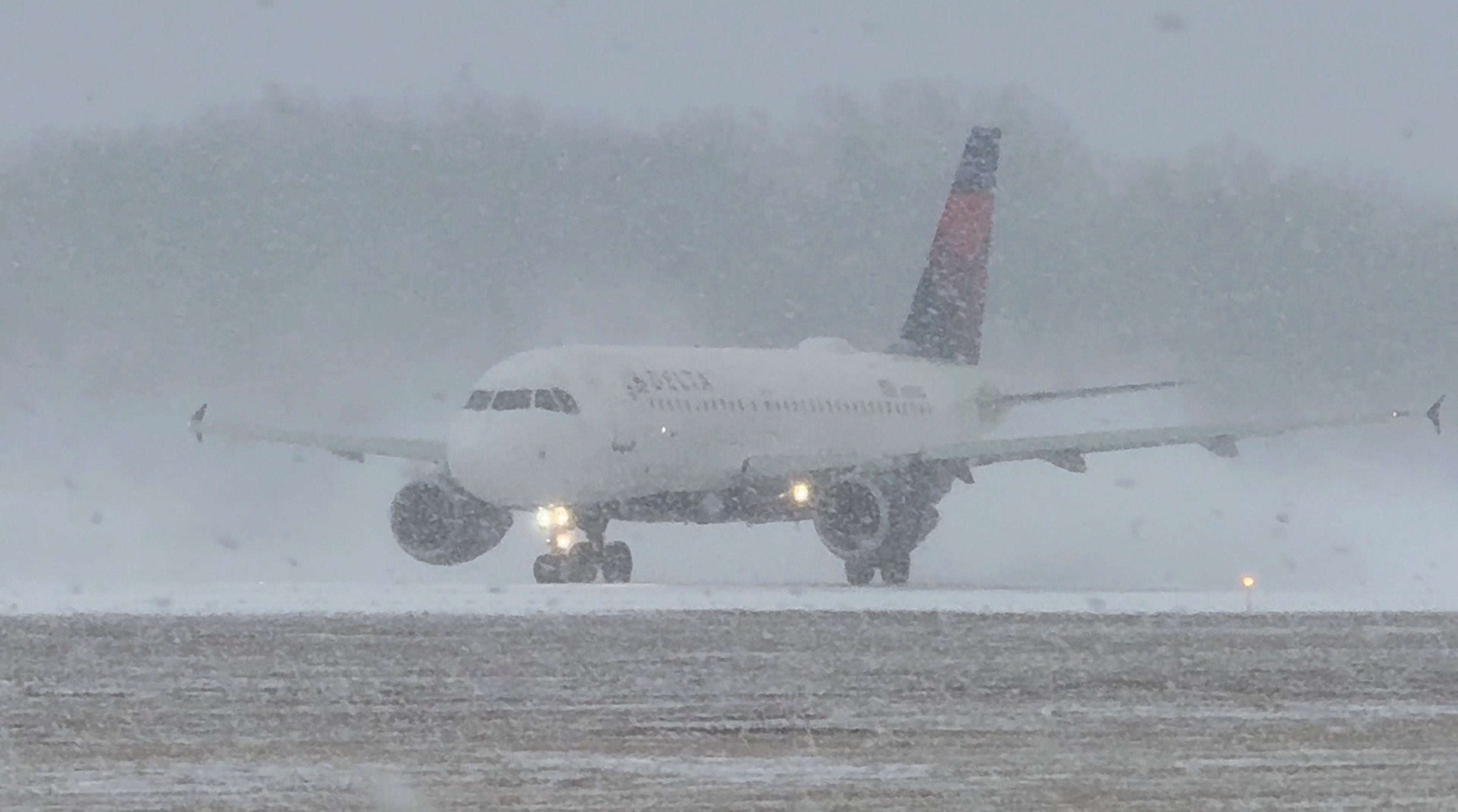 <p>A Delta Air Lines plane prepares to take off during a winter storm at Greater Rochester International Airport in Rochester, New York, U.S., December 26, 2025, in this screengrab obtained from a social media video</p>