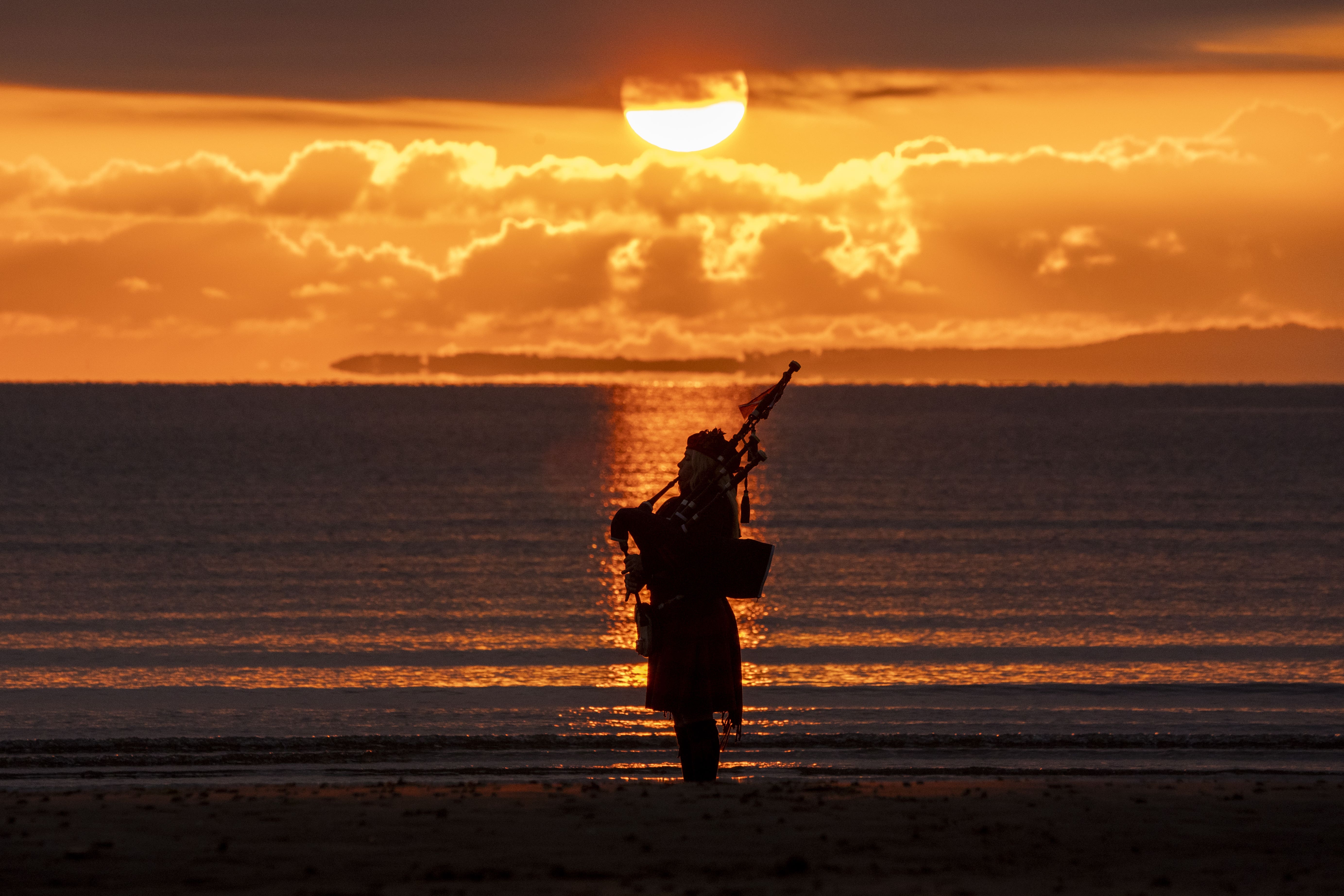 Scotland’s national piper Louise Marshall plays a lament to the fallen at dawn on Portobello Beach in Edinburgh on the anniversary of VE Day (Jane Barlow/PA)