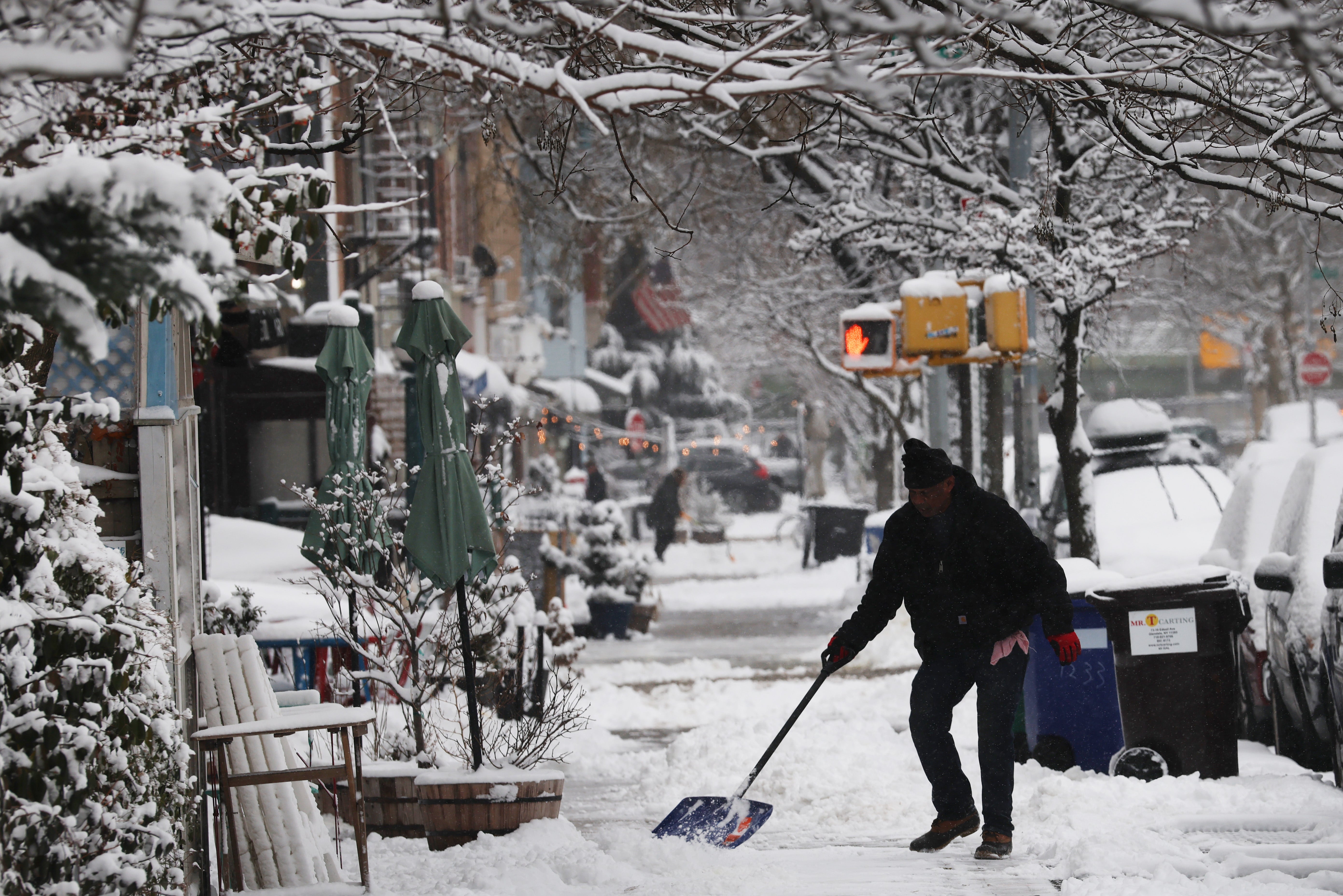 A man shovels snow in Brooklyn, New York City