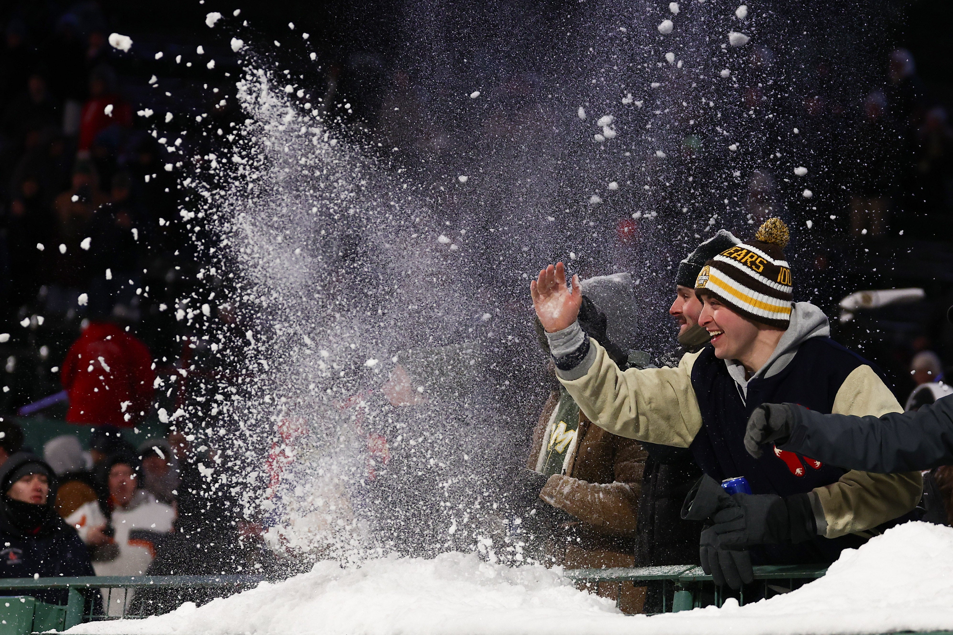 Army Black Knights fans throw snow after a touchdown during the second half of their win over the UConn Huskies in the Wasabi Fenway Bowl at Fenway Park in Boston, Massachusetts
