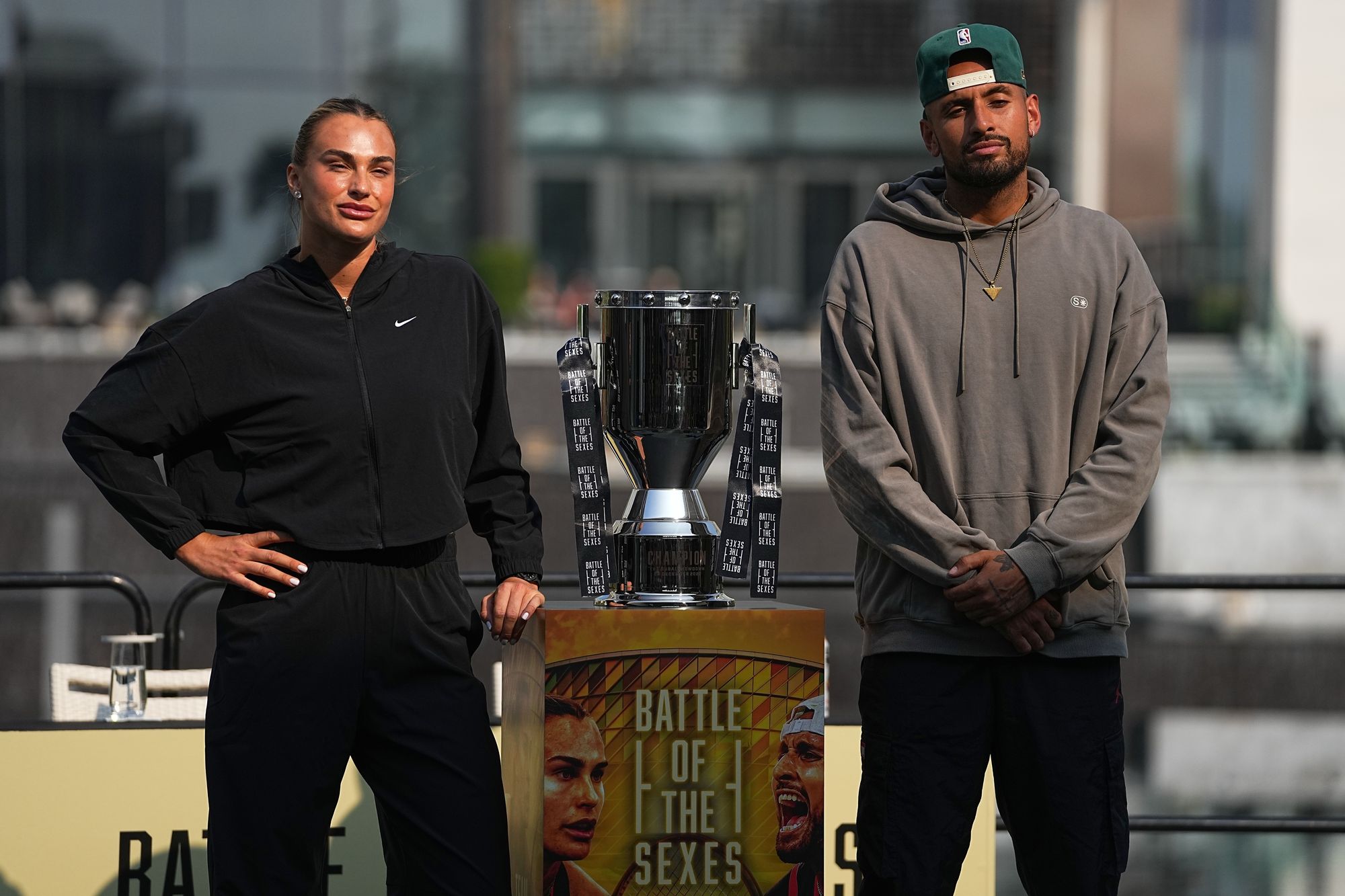 Sabalenka and Kyrgios poses with the Battle of the Sexes trophy