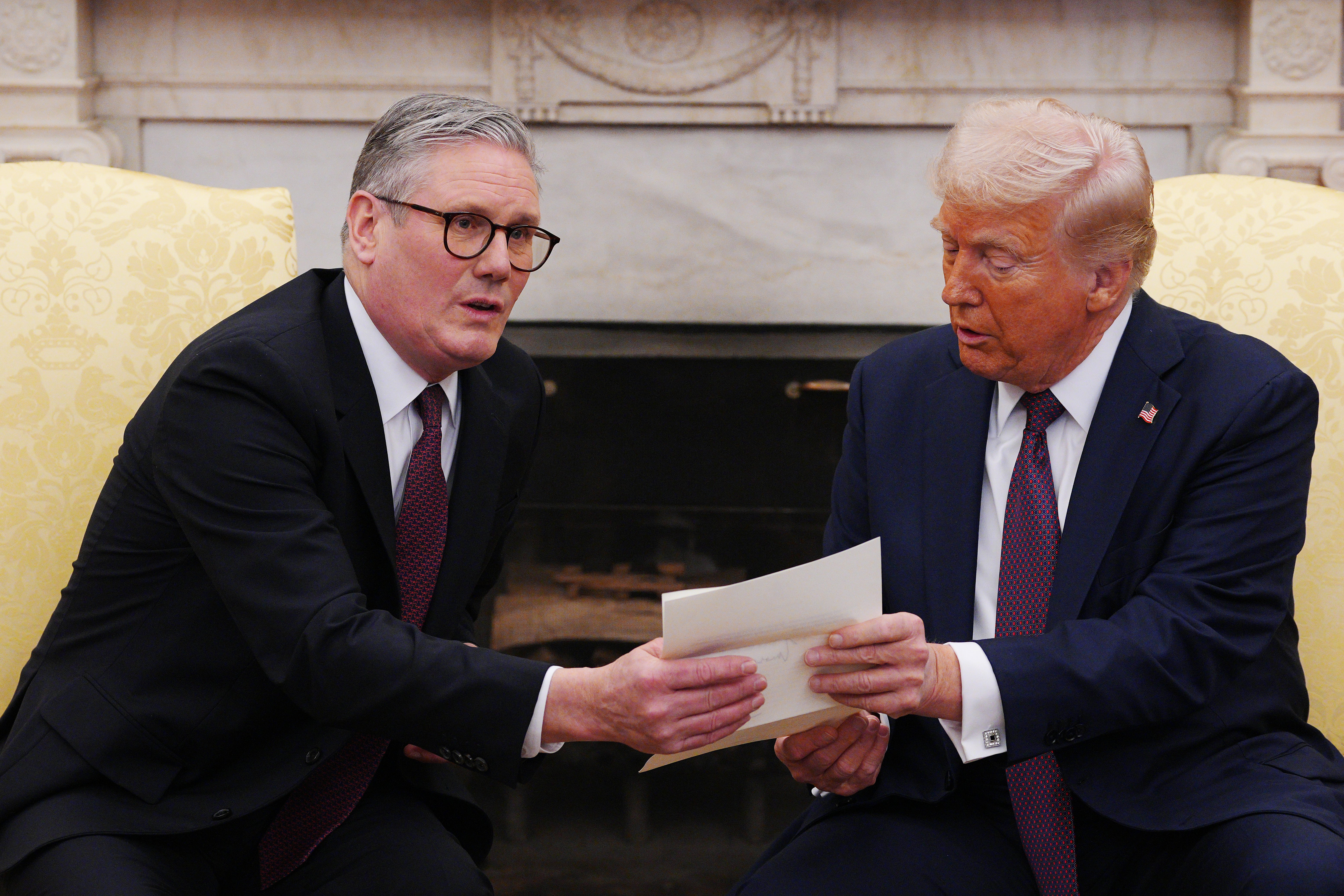 <p>US President Donald Trump is presented with a letter from the King during his meeting with Sir Keir Starmer in the Oval Office</p>